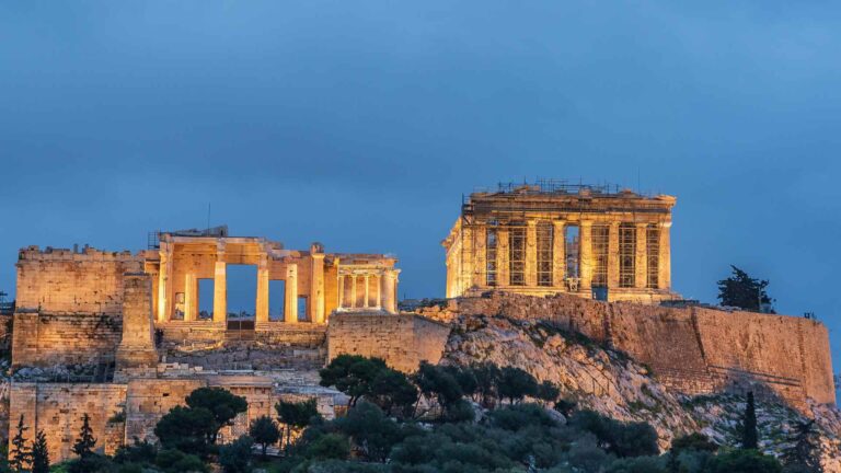 The illuminated Acropolis and Parthenon above Athens at dusk