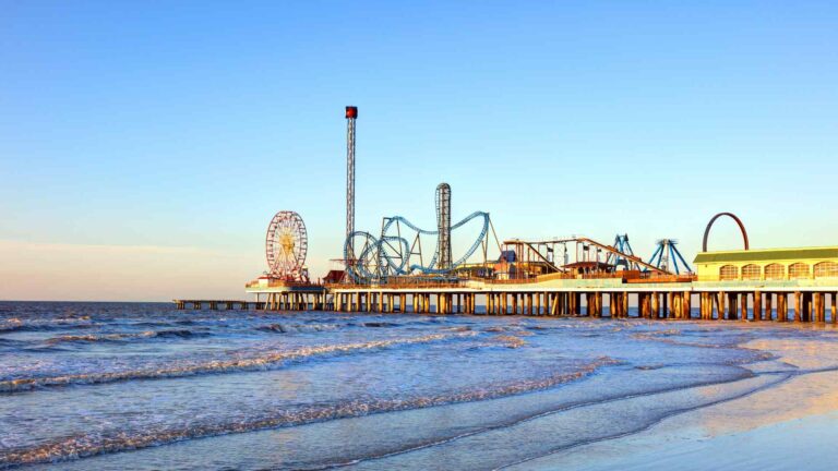 Galveston Island Historic Pleasure Pier extending over the water at dusk