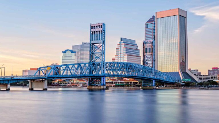 Jacksonville skyline and Main Street Bridge reflected in calm water at dusk