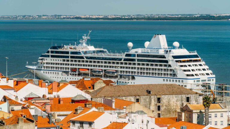 Cruise ship docked behind the red roofs of central Lisbon