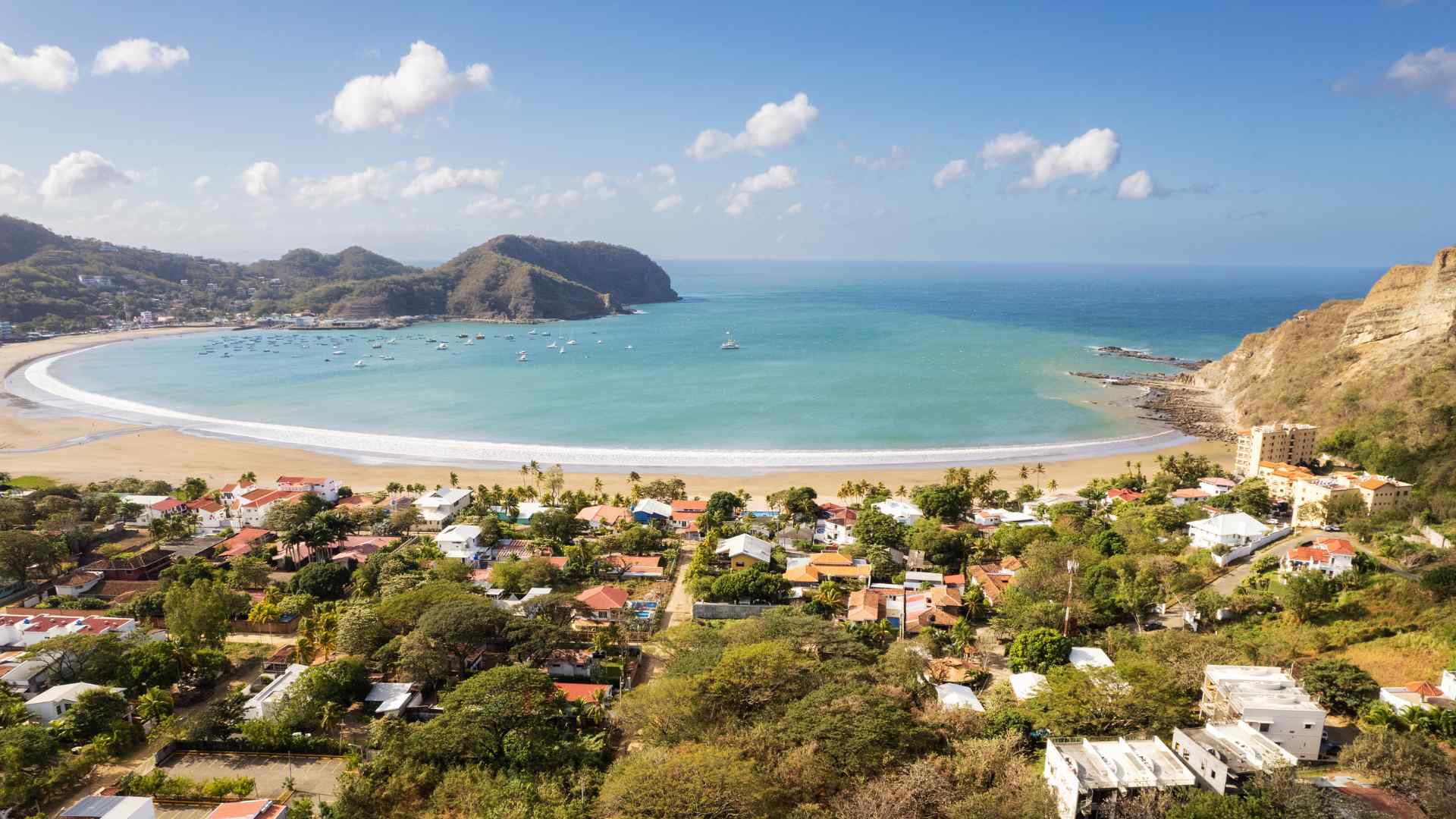 Curving tropical beach and green hills outside San Juan