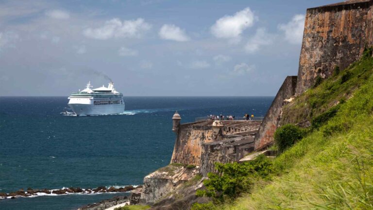 Cruise ship passing the cliffs and stone walls of El Morro in San Juan