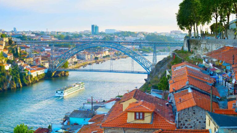 Porto rooftops and bridges overlooking boats on the Douro River