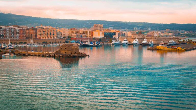 Civitavecchia harbor and waterfront buildings glowing in evening light