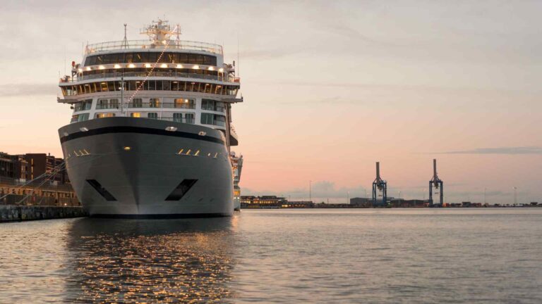 Cruise ship facing the camera in Copenhagen harbor at sunset