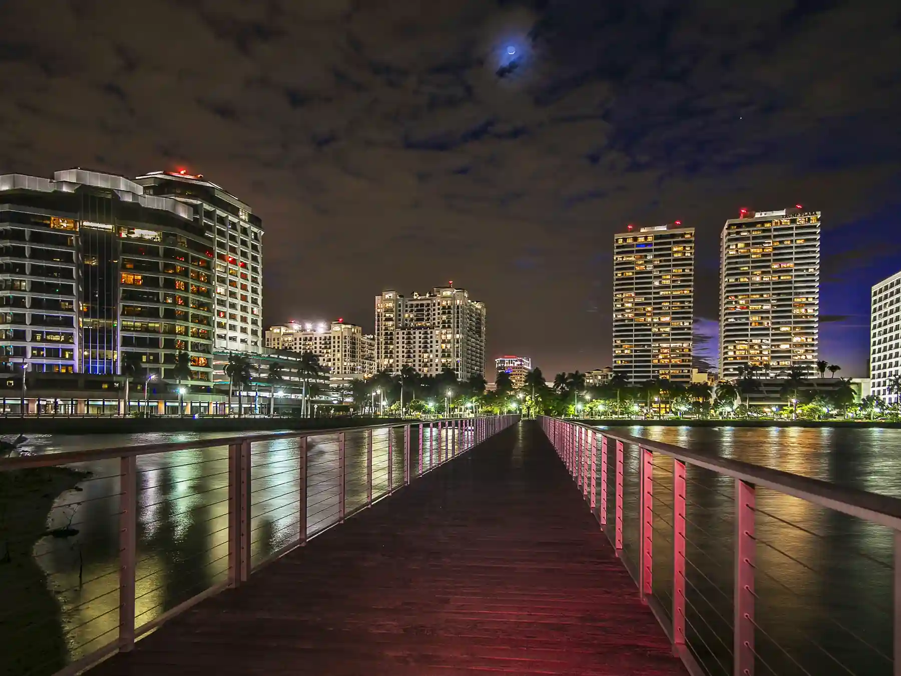 West Palm Beach skyline lights reflected on the waterfront at night.