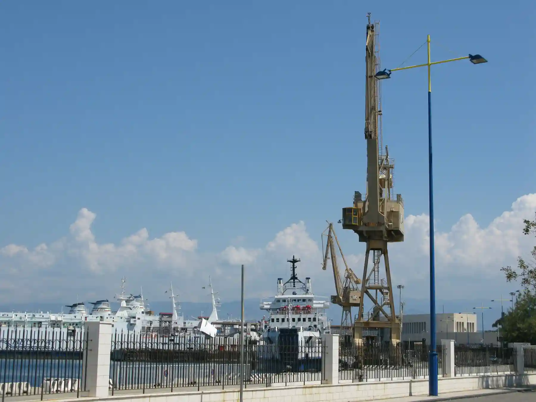 Cargo cranes and vessels at the Port of Messina.