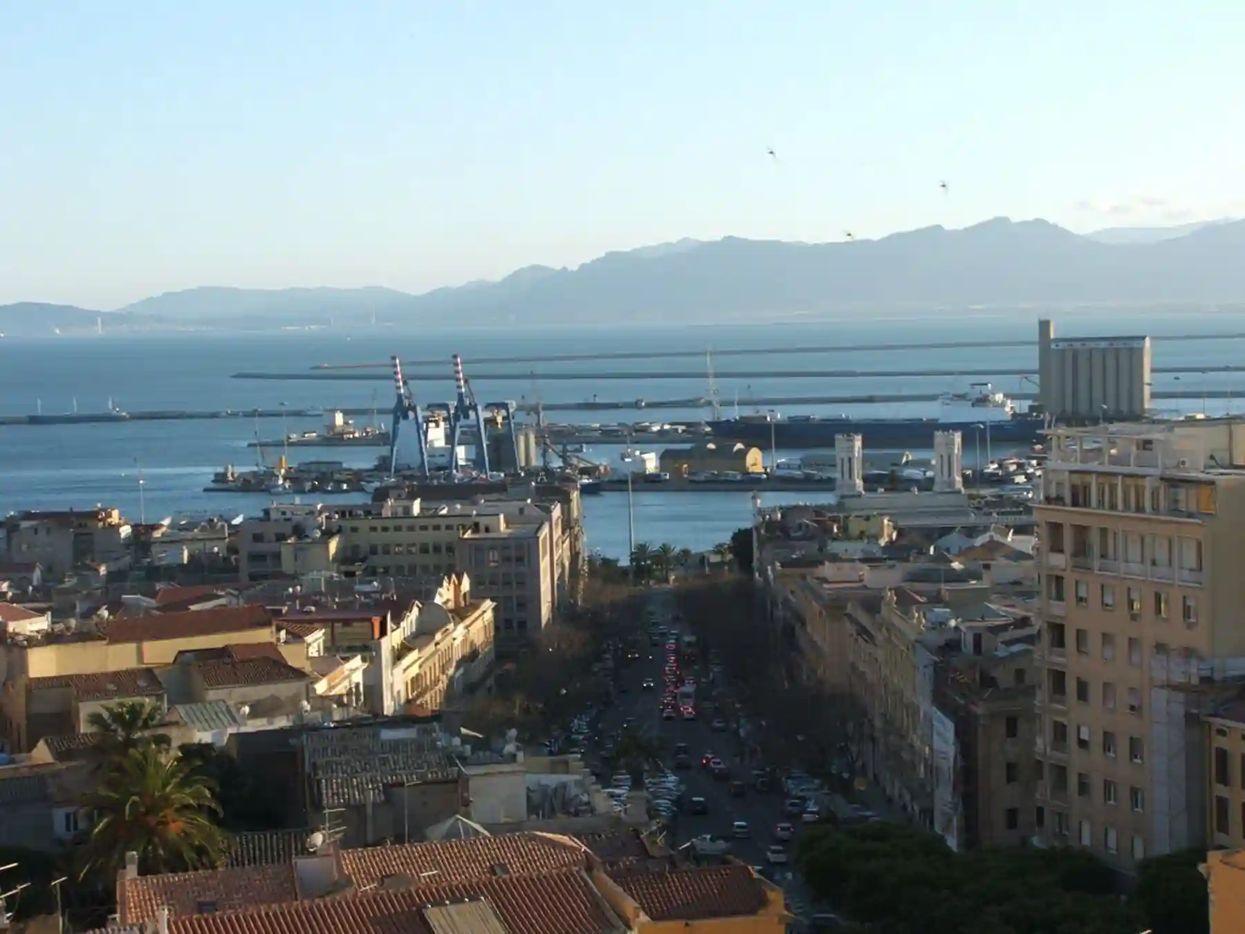 Cagliari harbor and city waterfront viewed from above.