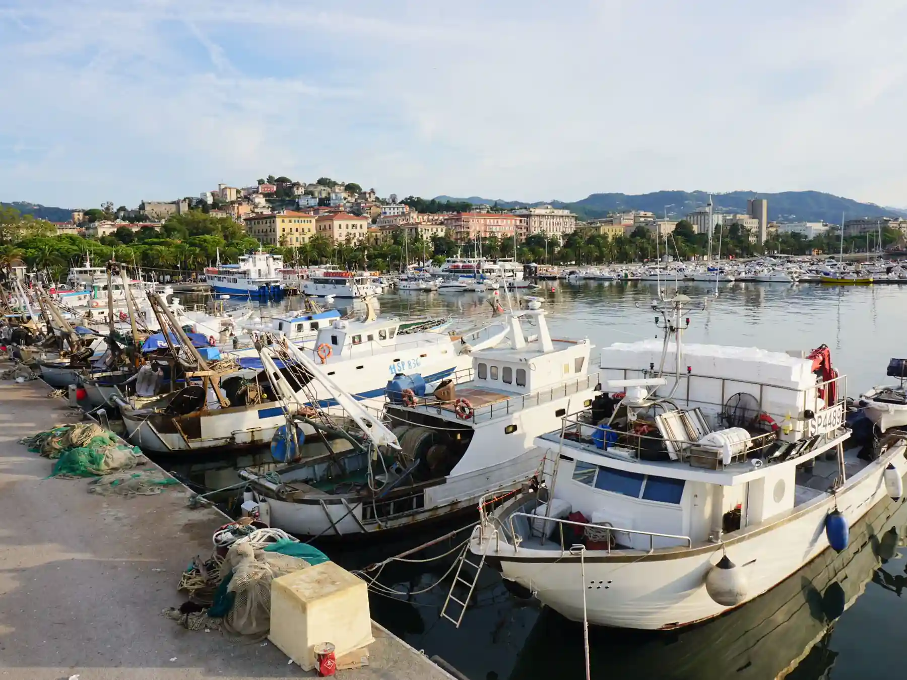Fishing boats moored along the waterfront in La Spezia, Italy.