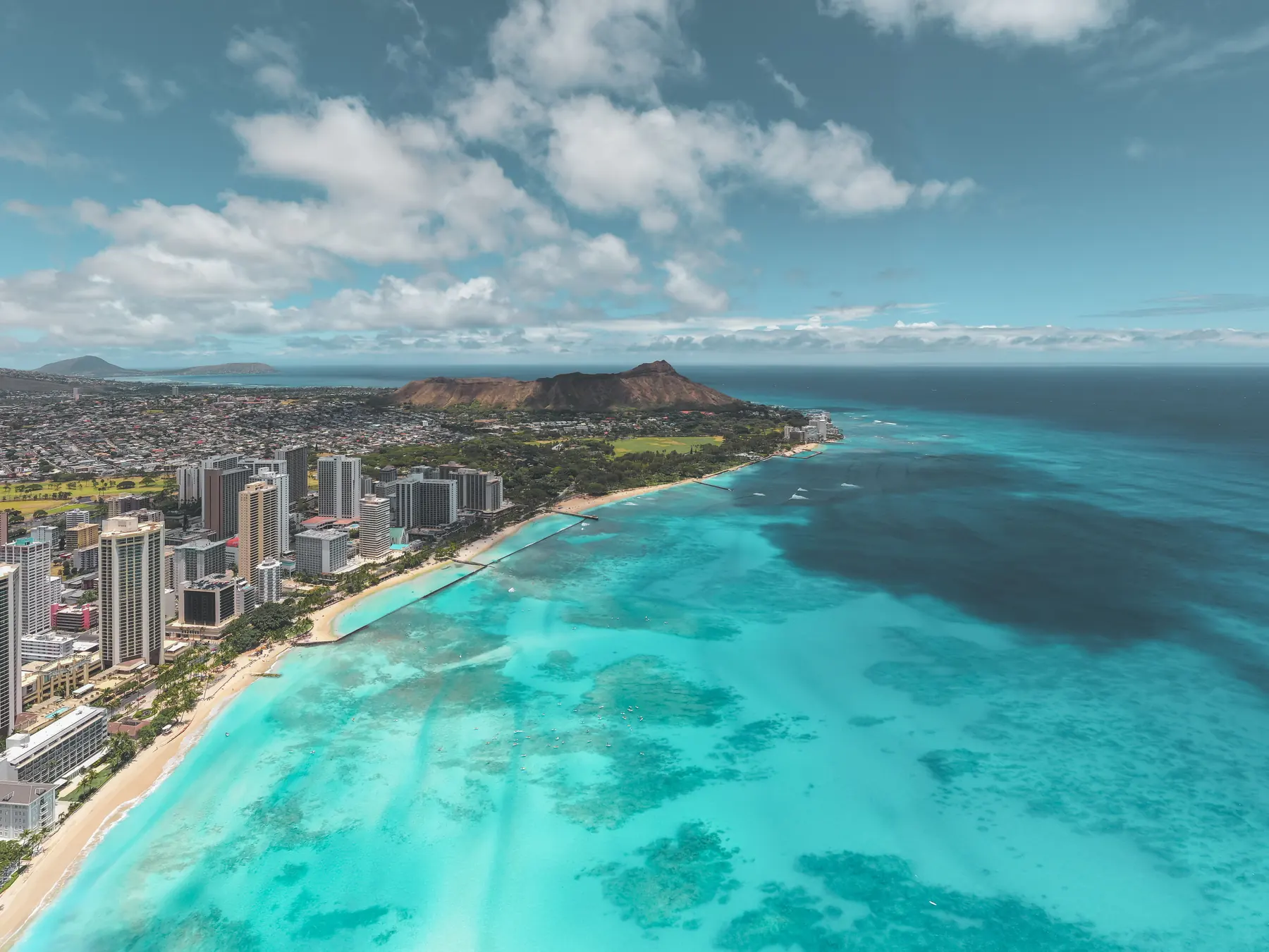 Aerial view of Waikiki’s coastline with Diamond Head beyond Honolulu.