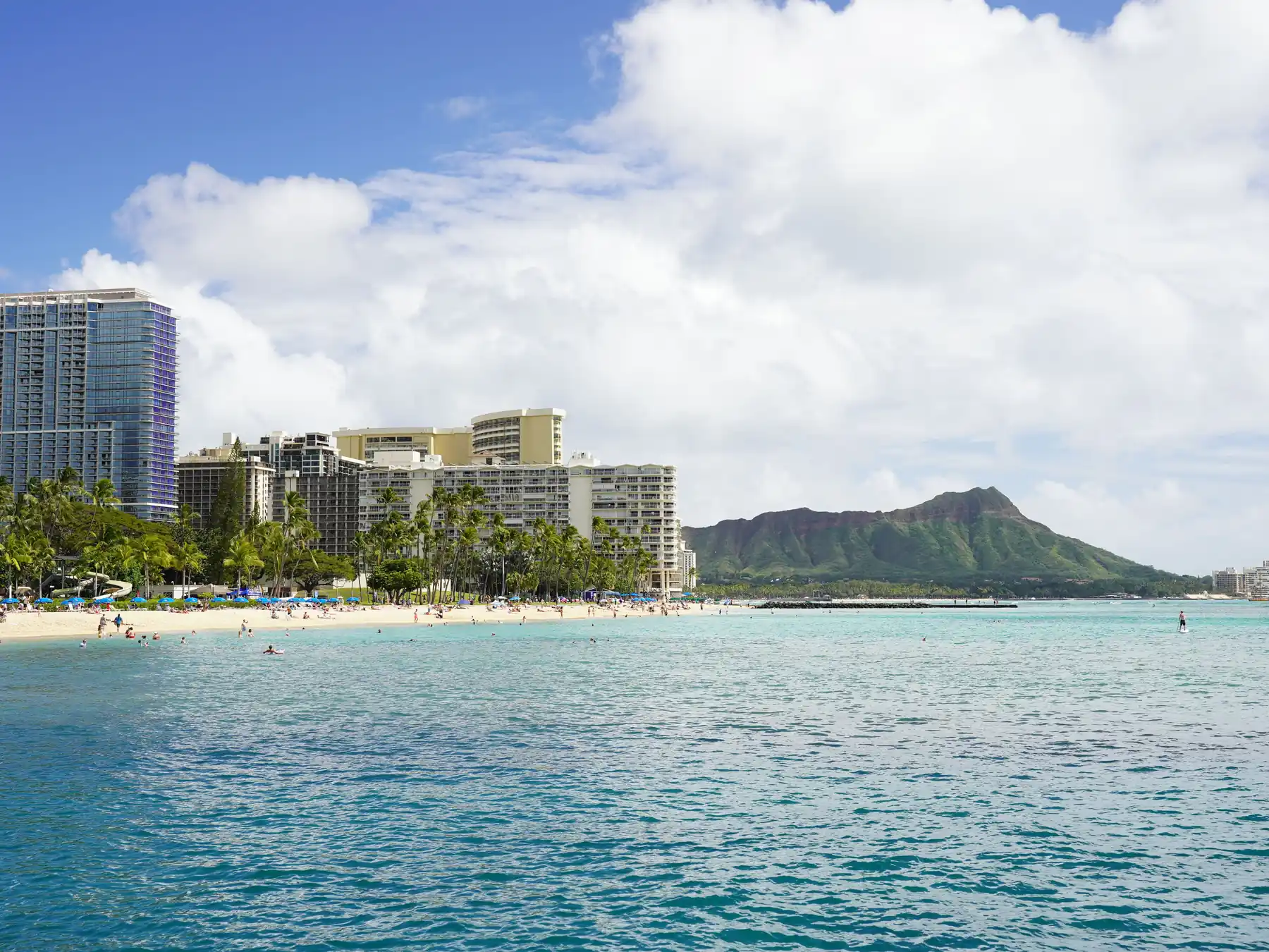 Waikiki Beach and beachfront hotels with Diamond Head in the distance.