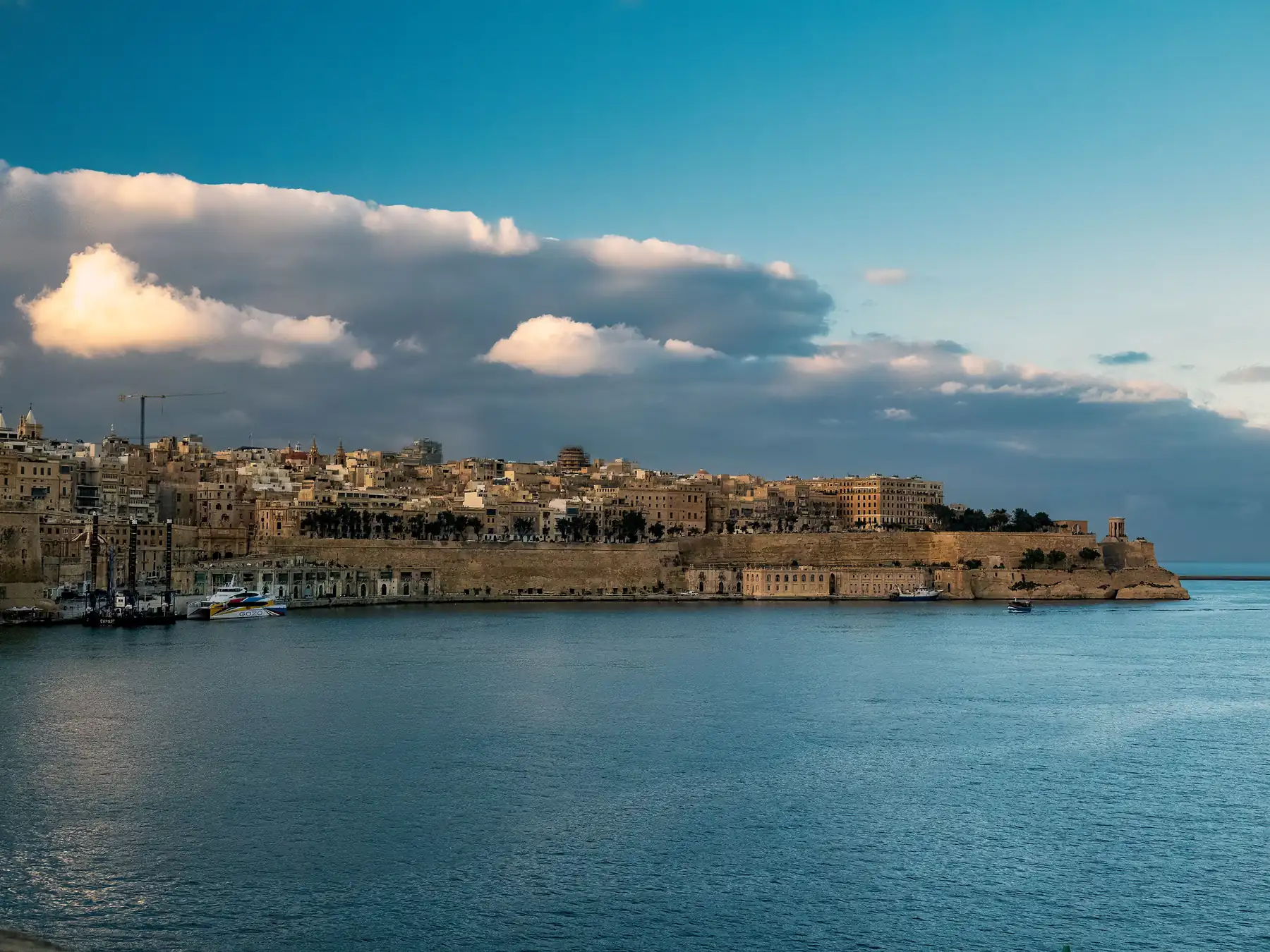 Historic Valletta waterfront and fortified city walls beside Grand Harbour.