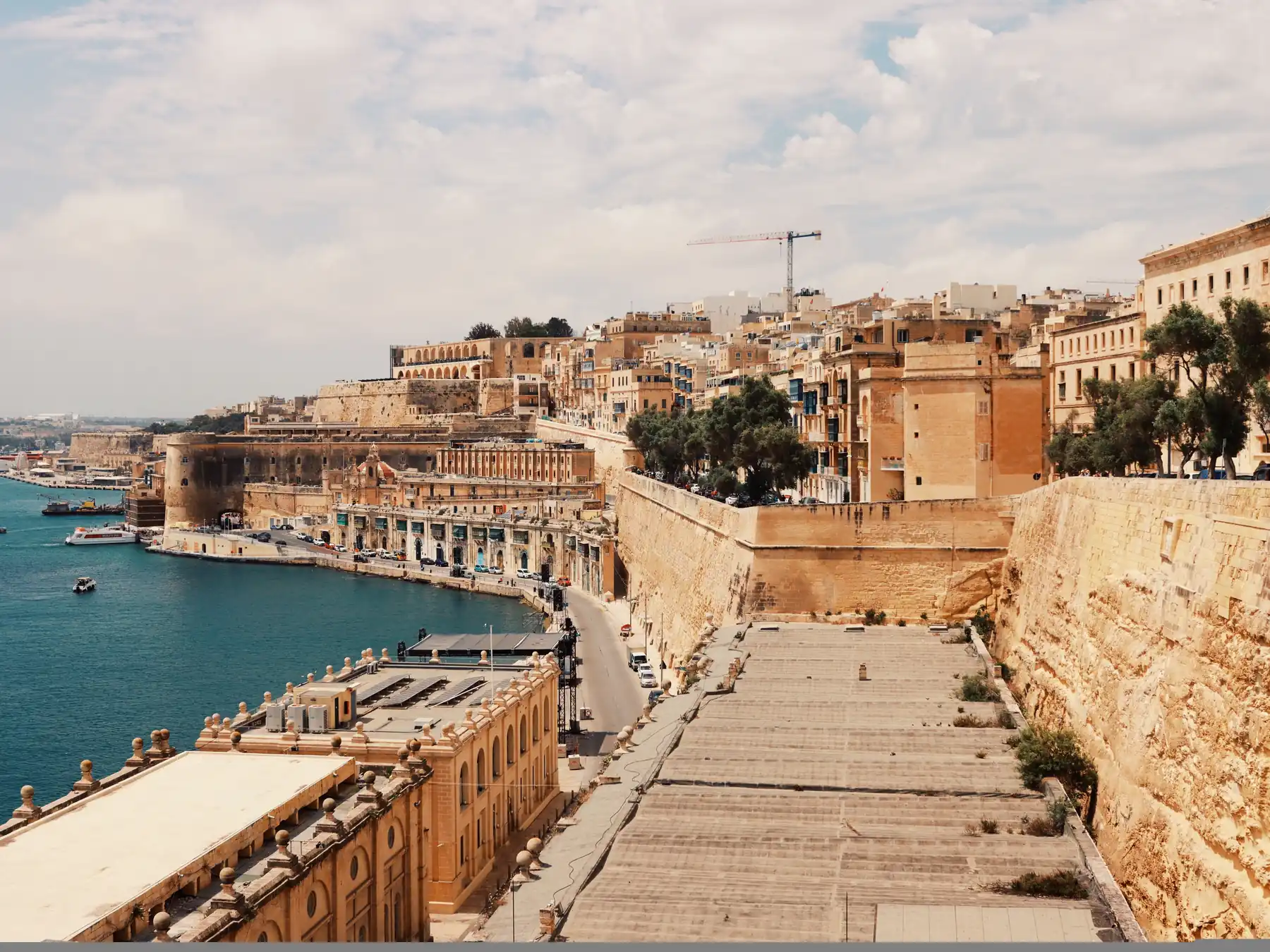 Valletta’s stone fortifications and waterfront buildings overlooking Grand Harbour.