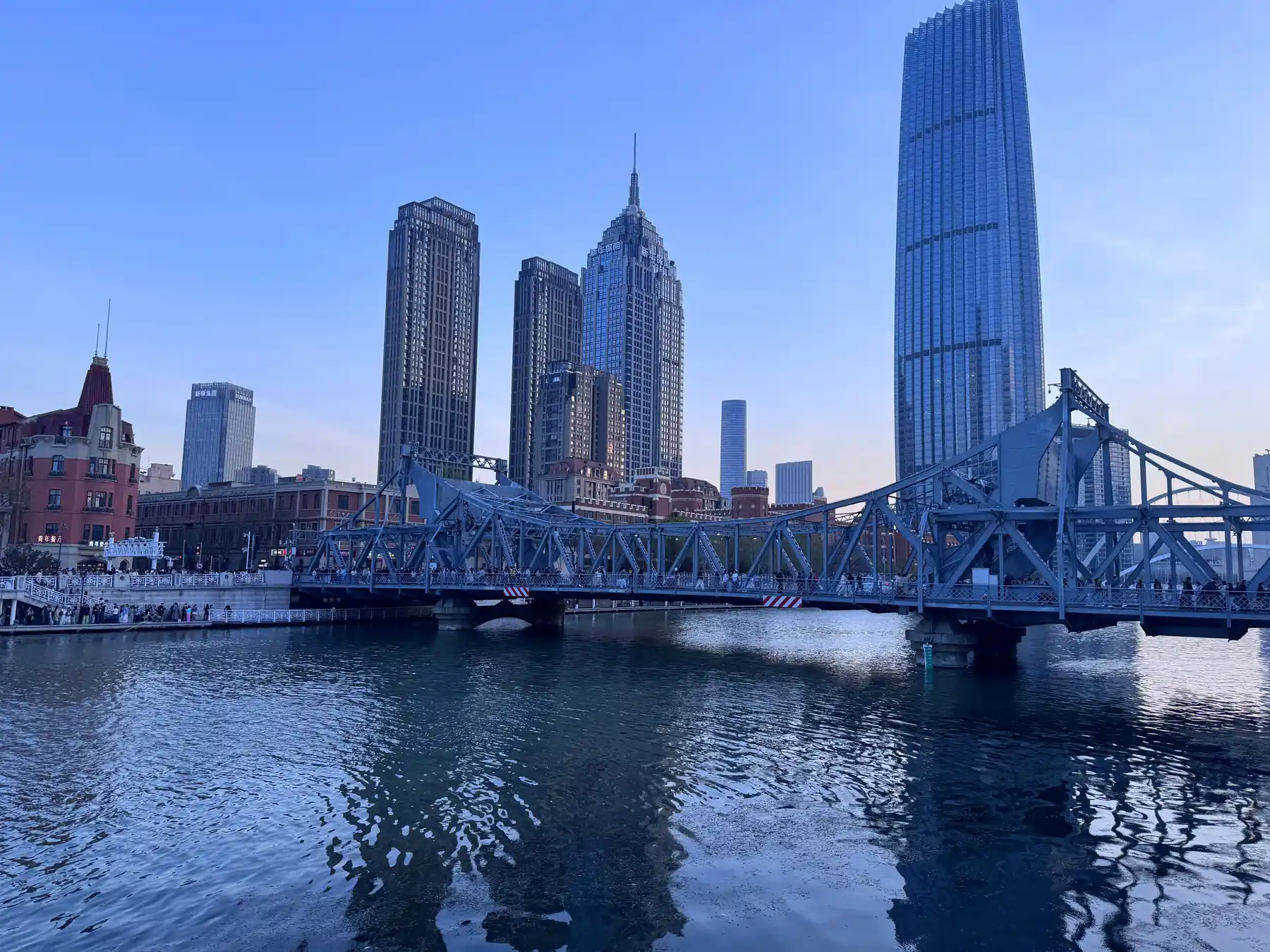Jinwan Plaza skyline and a steel bridge over the Haihe River in Tianjin.