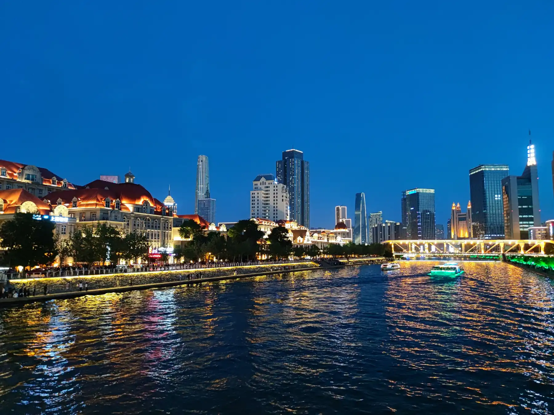 Illuminated buildings reflecting on the Haihe River in central Tianjin at night.