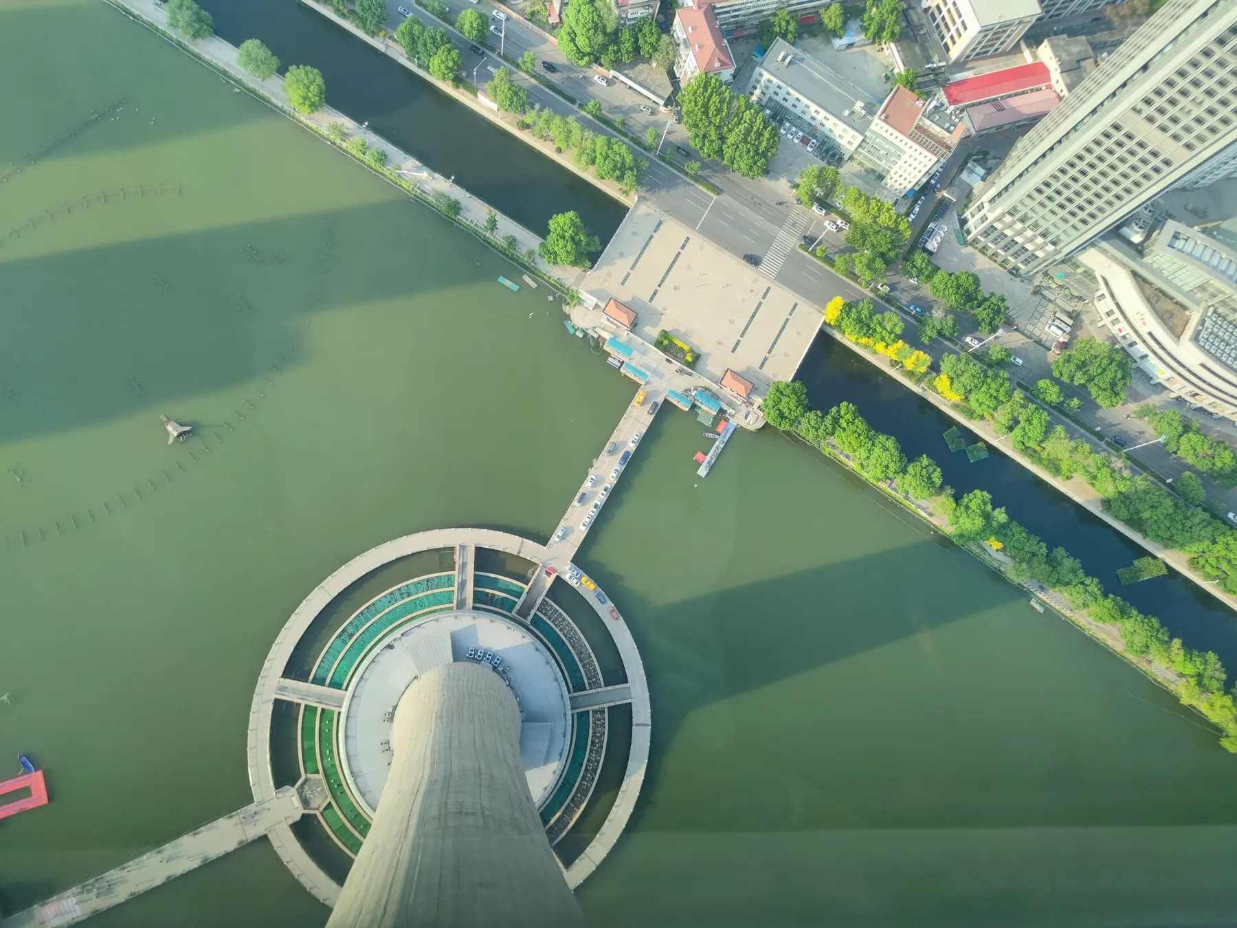 Aerial view from Tianjin Tower looking down across the Haihe River and city streets.