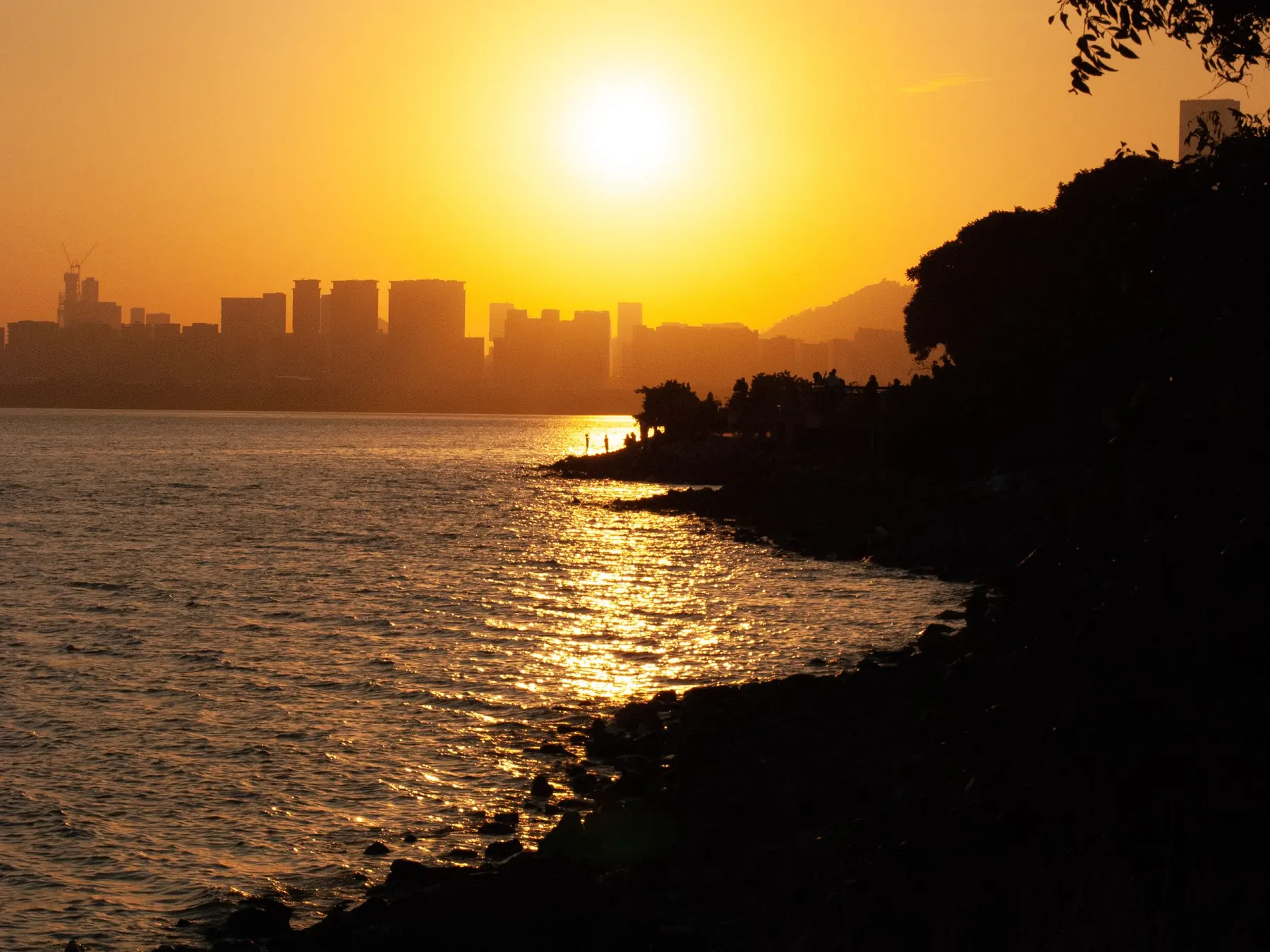 Sunset over Shenzhen’s waterfront and silhouetted city skyline.