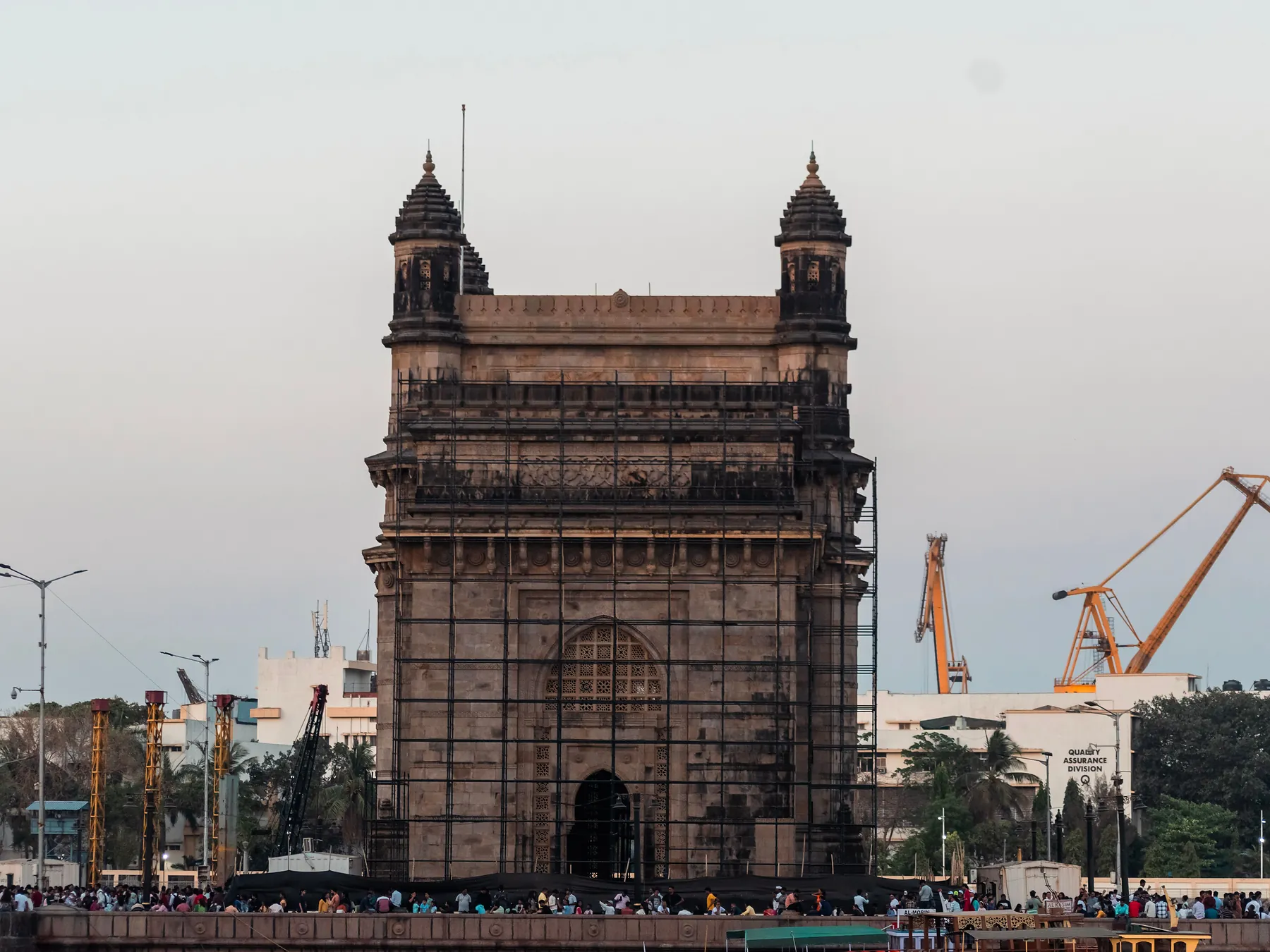 Gateway of India with Mumbai port cranes in the background