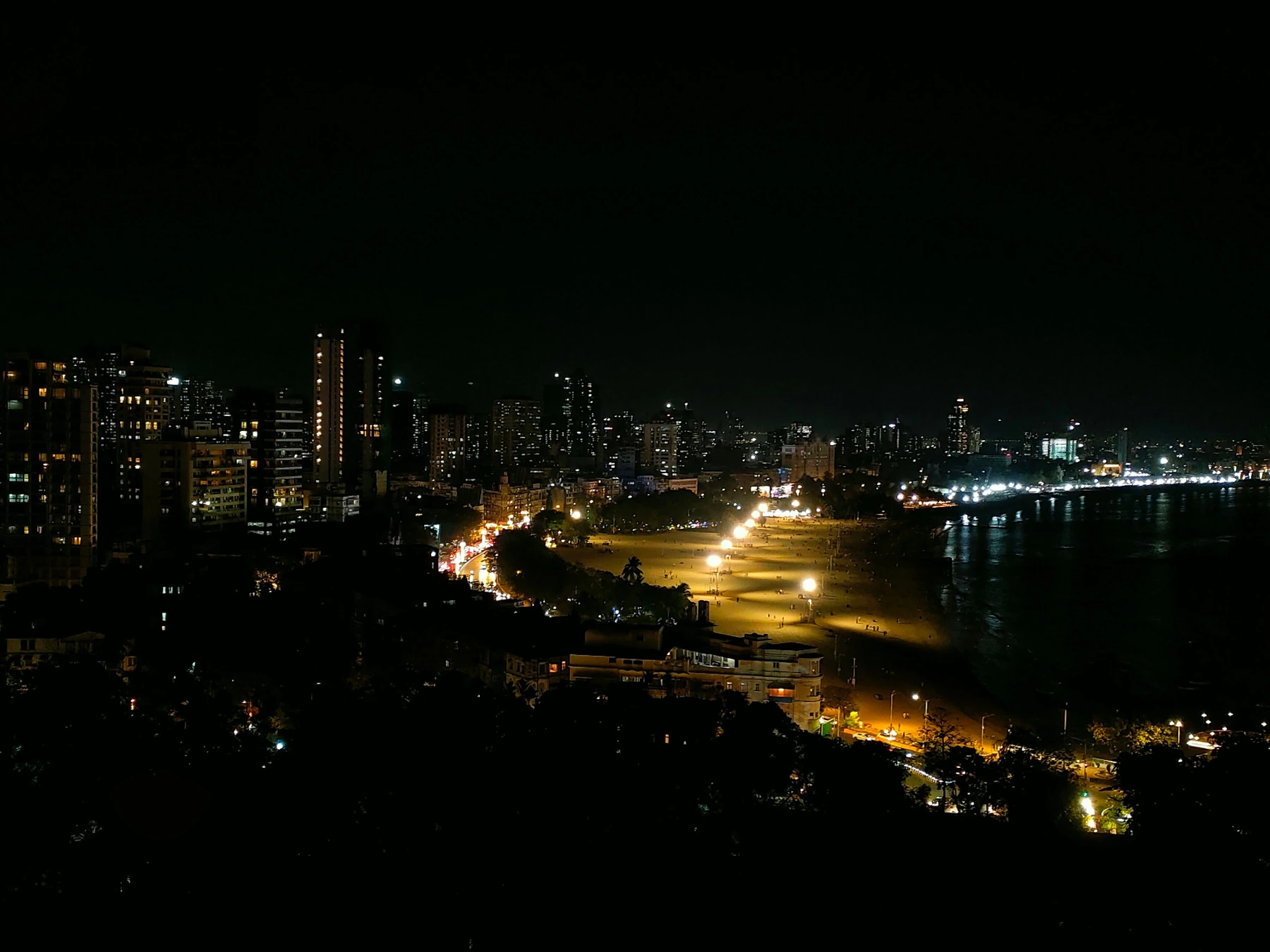 Illuminated Mumbai skyline along Marine Drive at night