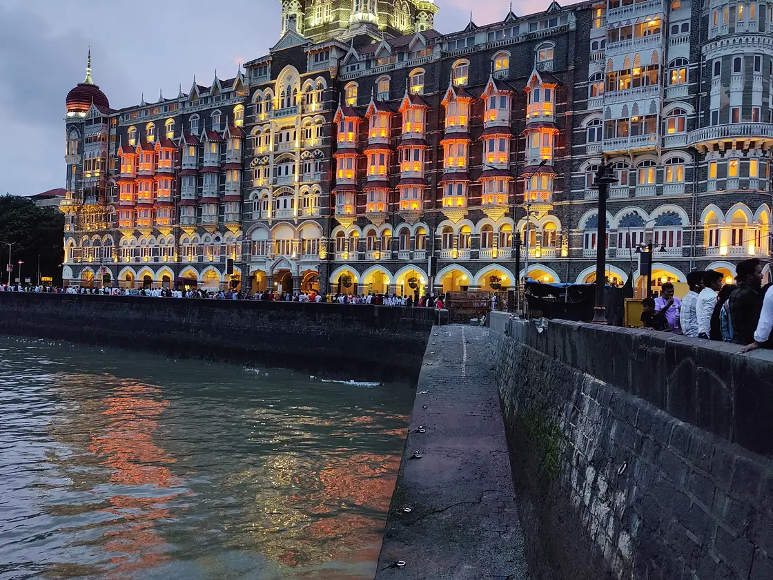 Taj Mahal Palace Hotel illuminated at dusk in Mumbai