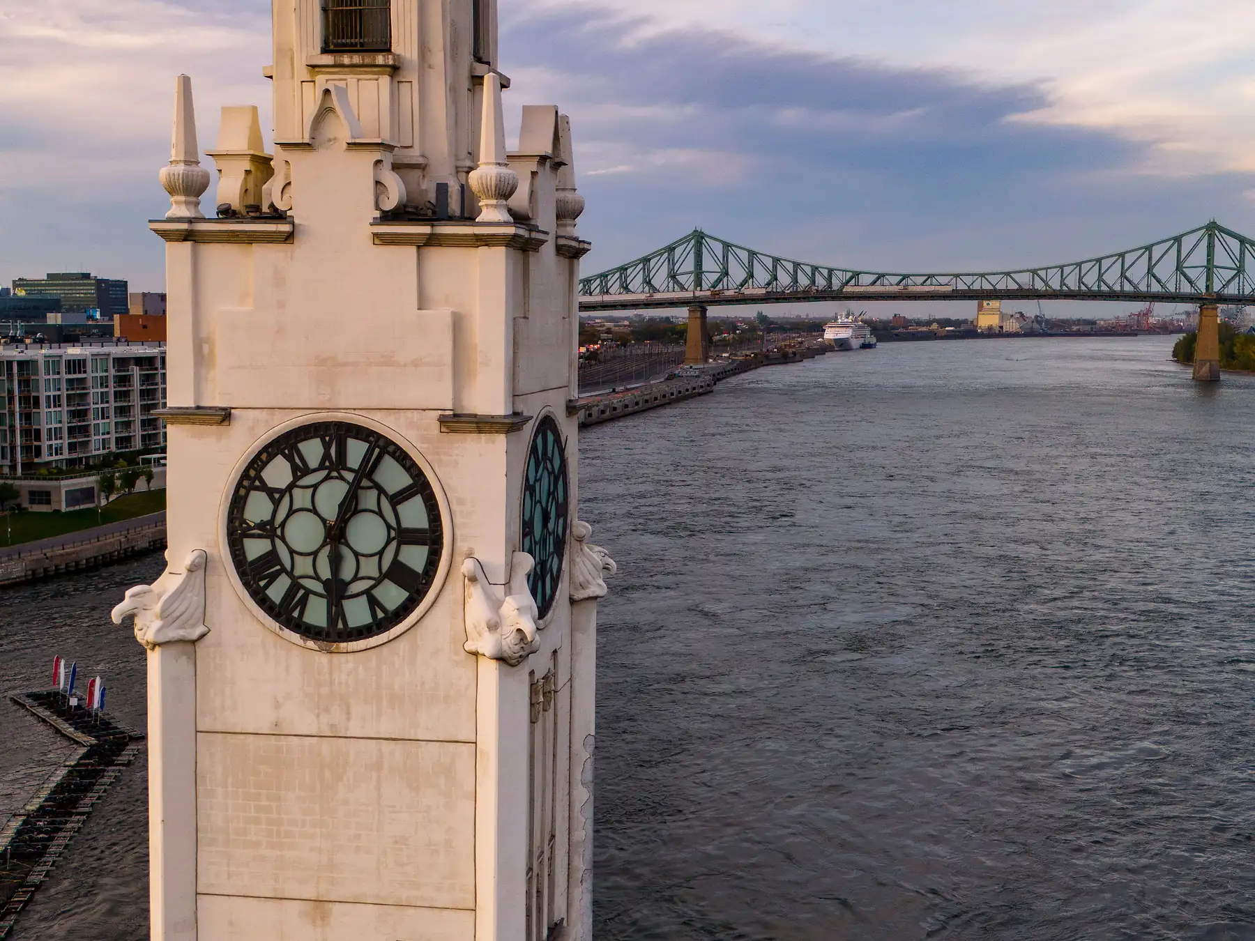 Montréal Clock Tower by the river with Jacques Cartier Bridge beyond