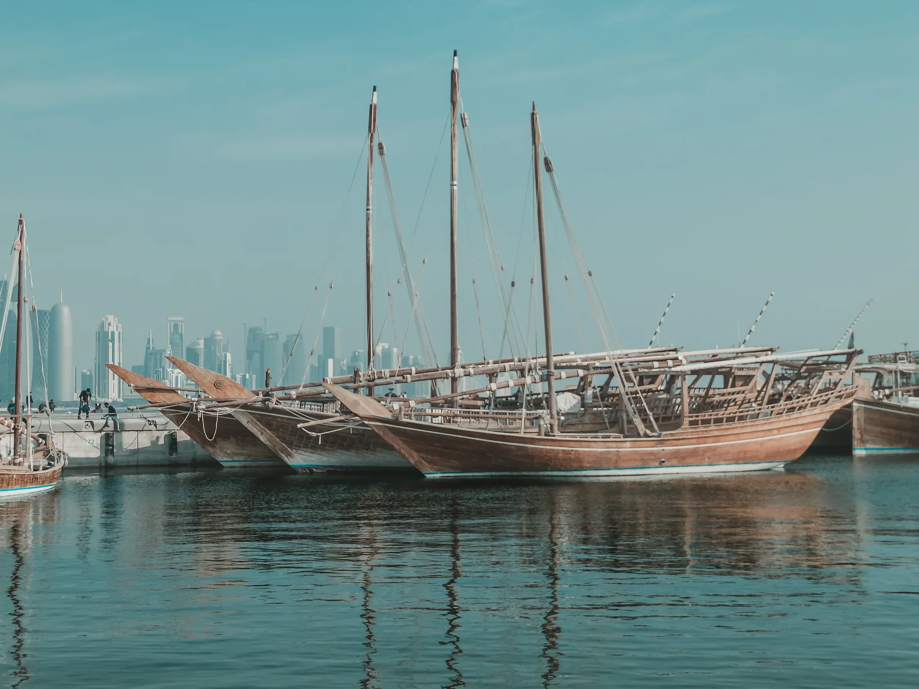 Traditional dhow boats docked along Doha's waterfront