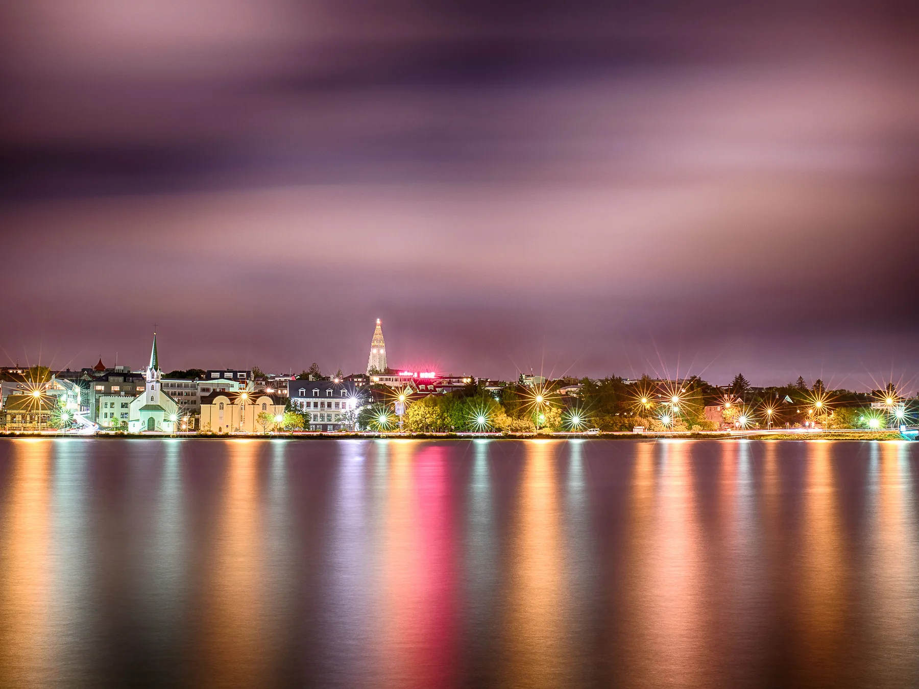 Reykjavík city lights reflected on the waterfront at night