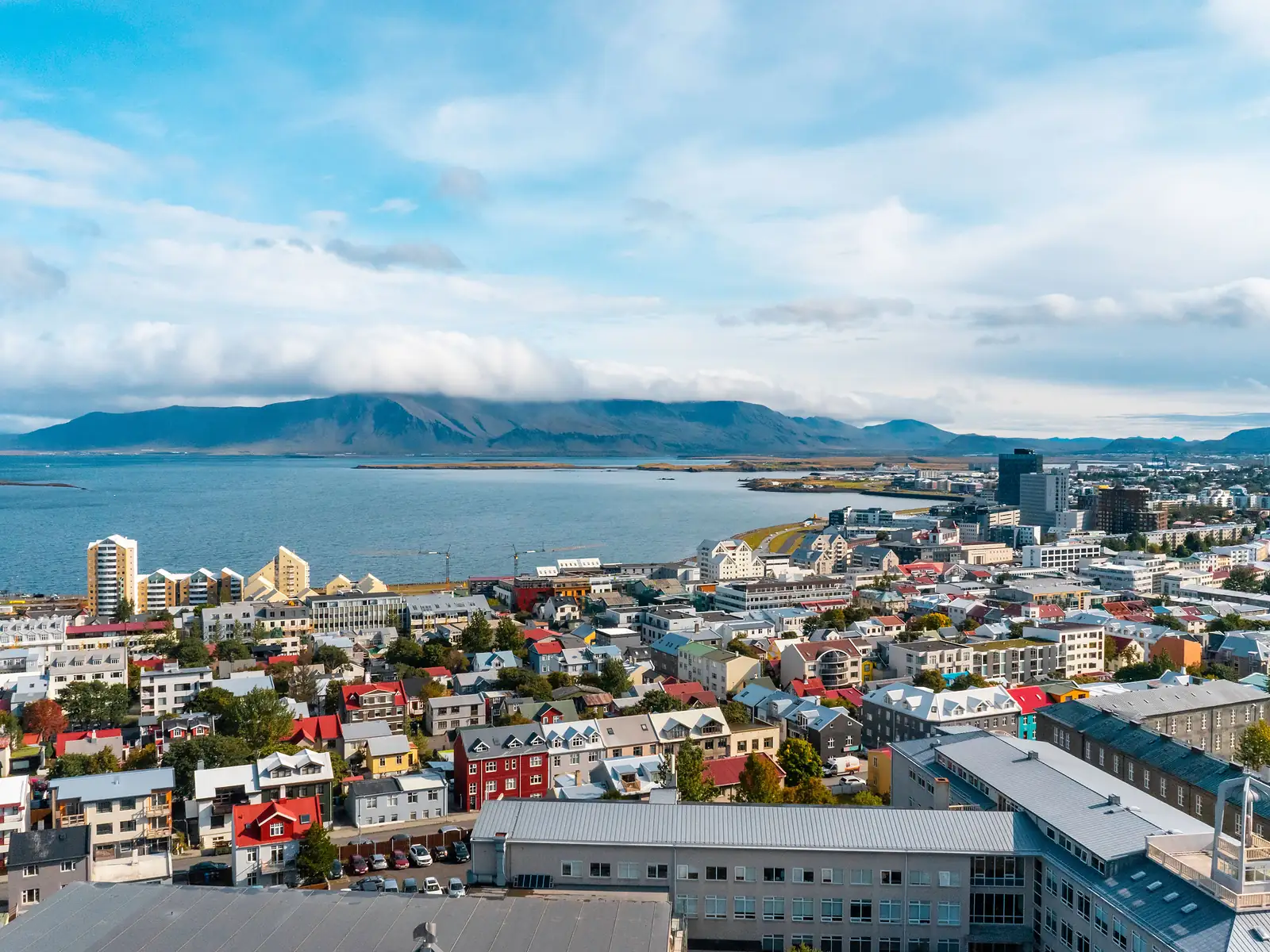 Aerial view of Reykjavík's colorful cityscape beside the ocean