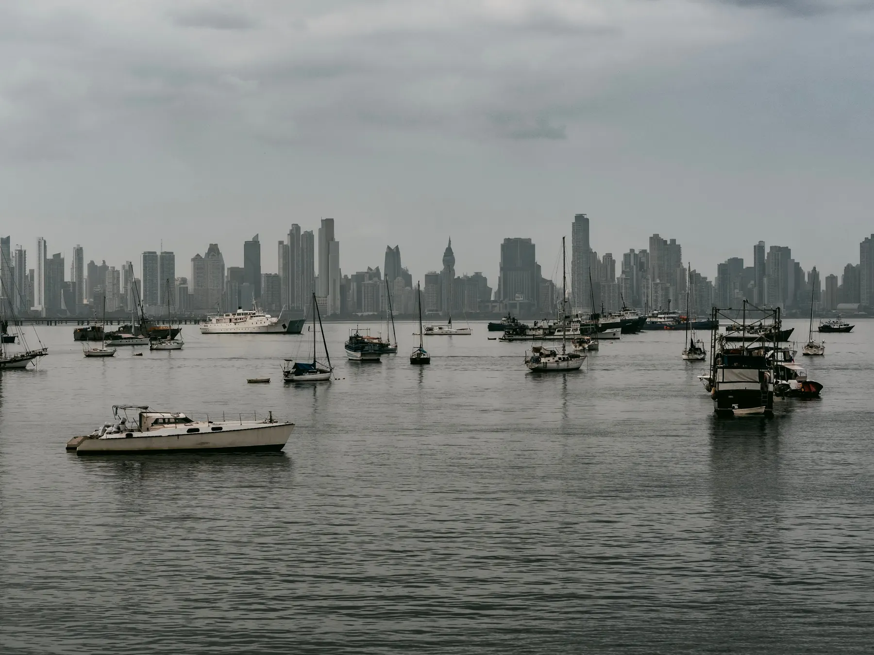 Boats in Panama City harbor with the modern skyline beyond.