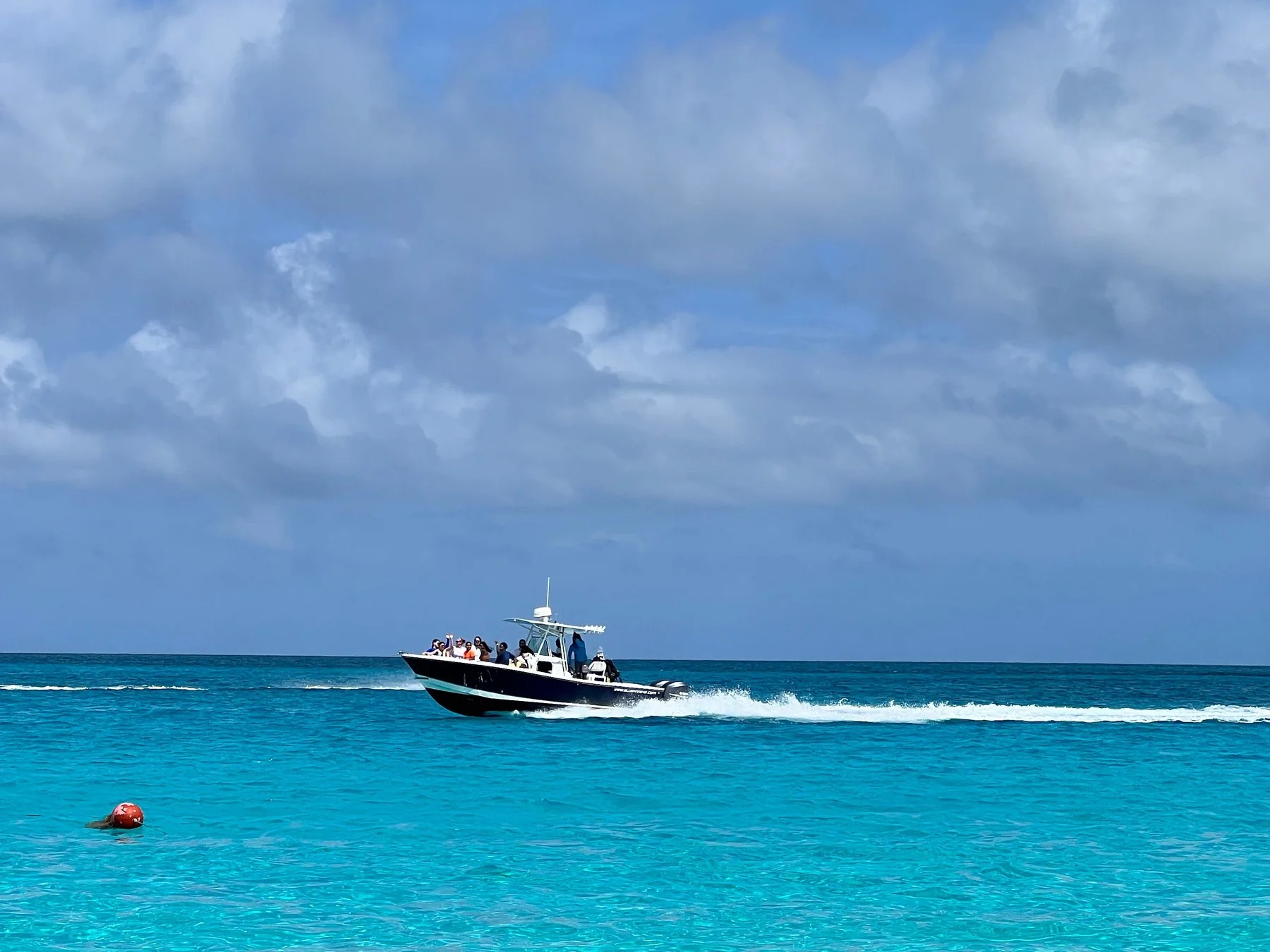 Speedboat crossing vivid turquoise water off Nassau, Bahamas.