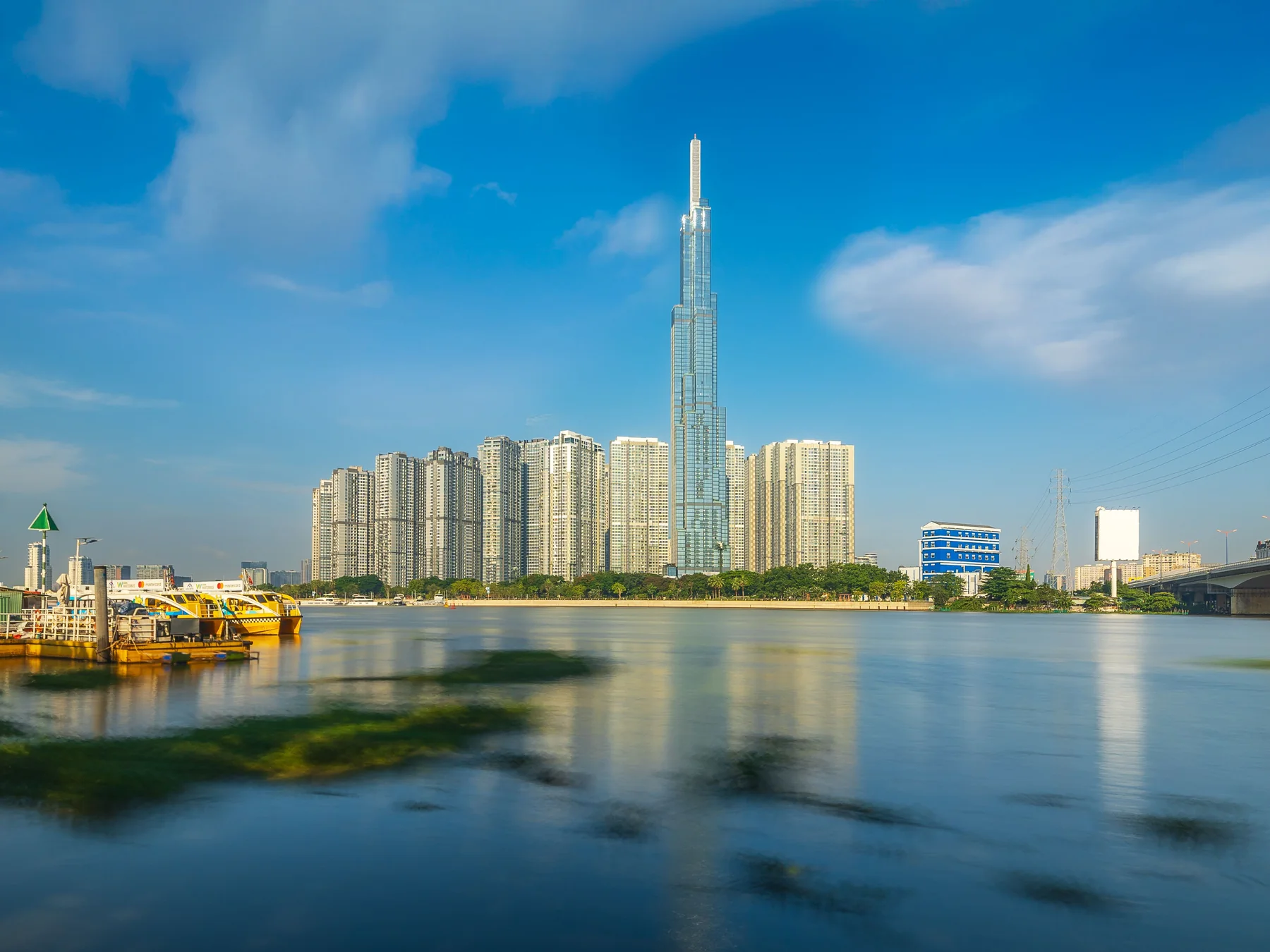 Landmark 81 rising above Ho Chi Minh City's skyline beside the Saigon River.