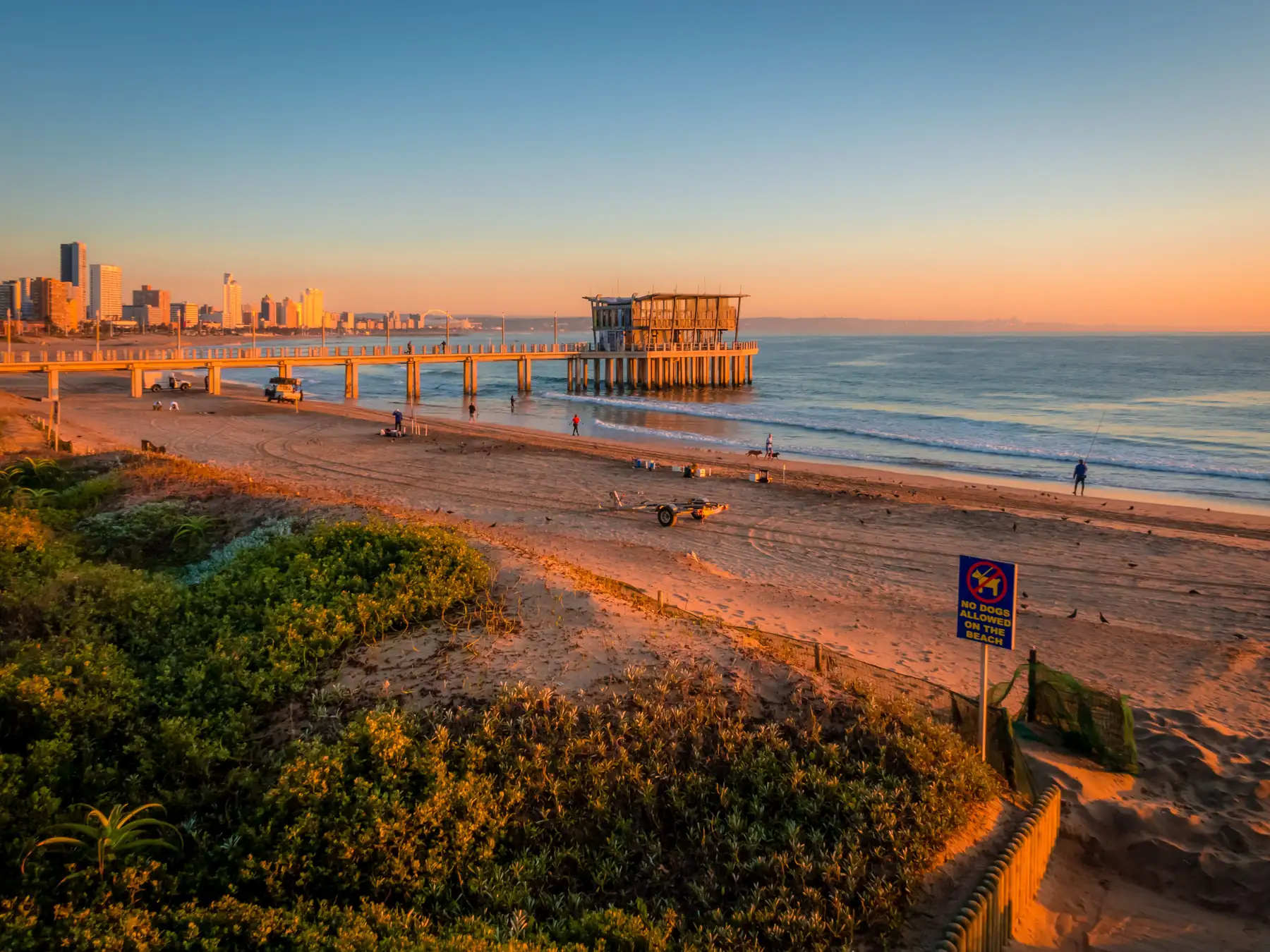 Durban beachfront pier extending into the ocean at sunrise.