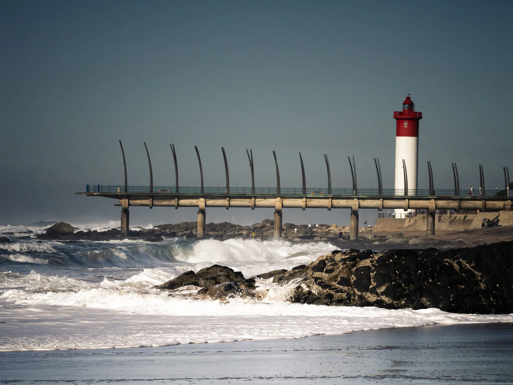 Lighthouse and waves along Durban's Golden Mile waterfront.