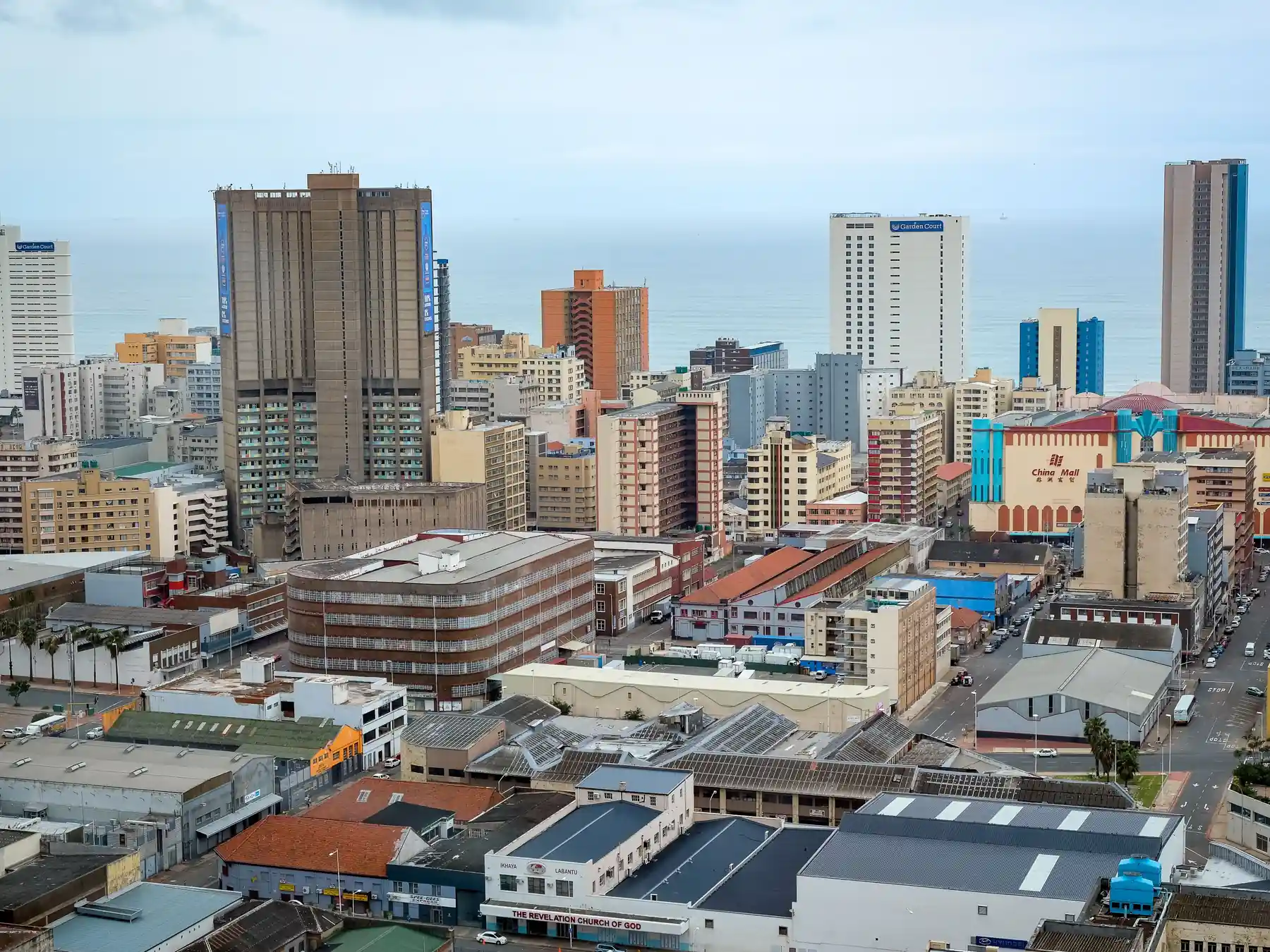 Panoramic view of Durban's modern skyline beside the Indian Ocean.