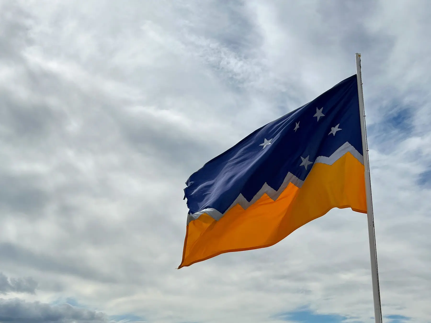 Patagonian flag flying above the waterfront in Punta Arenas, Chile.