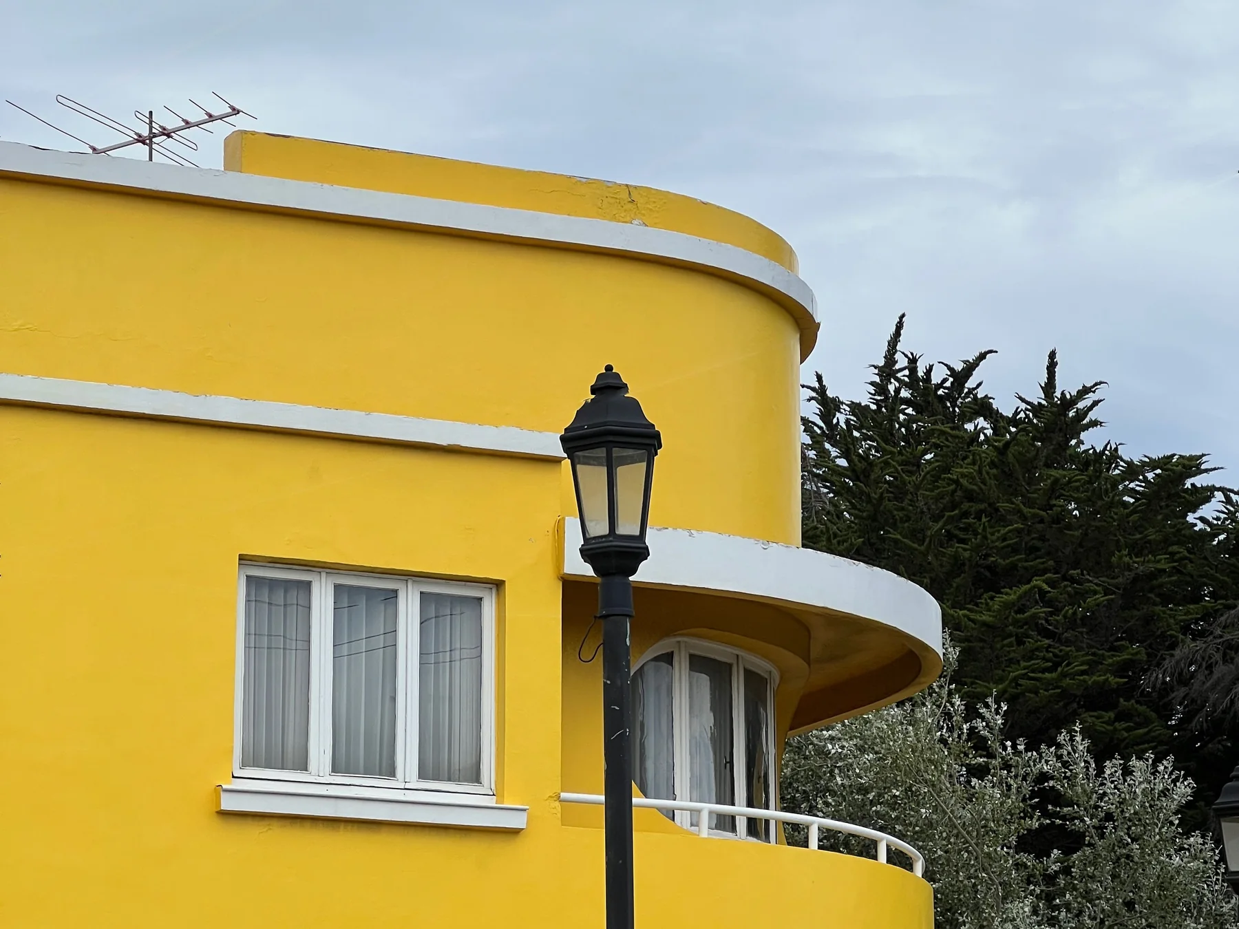 Yellow Art Deco building and street lantern in Punta Arenas, Chile.