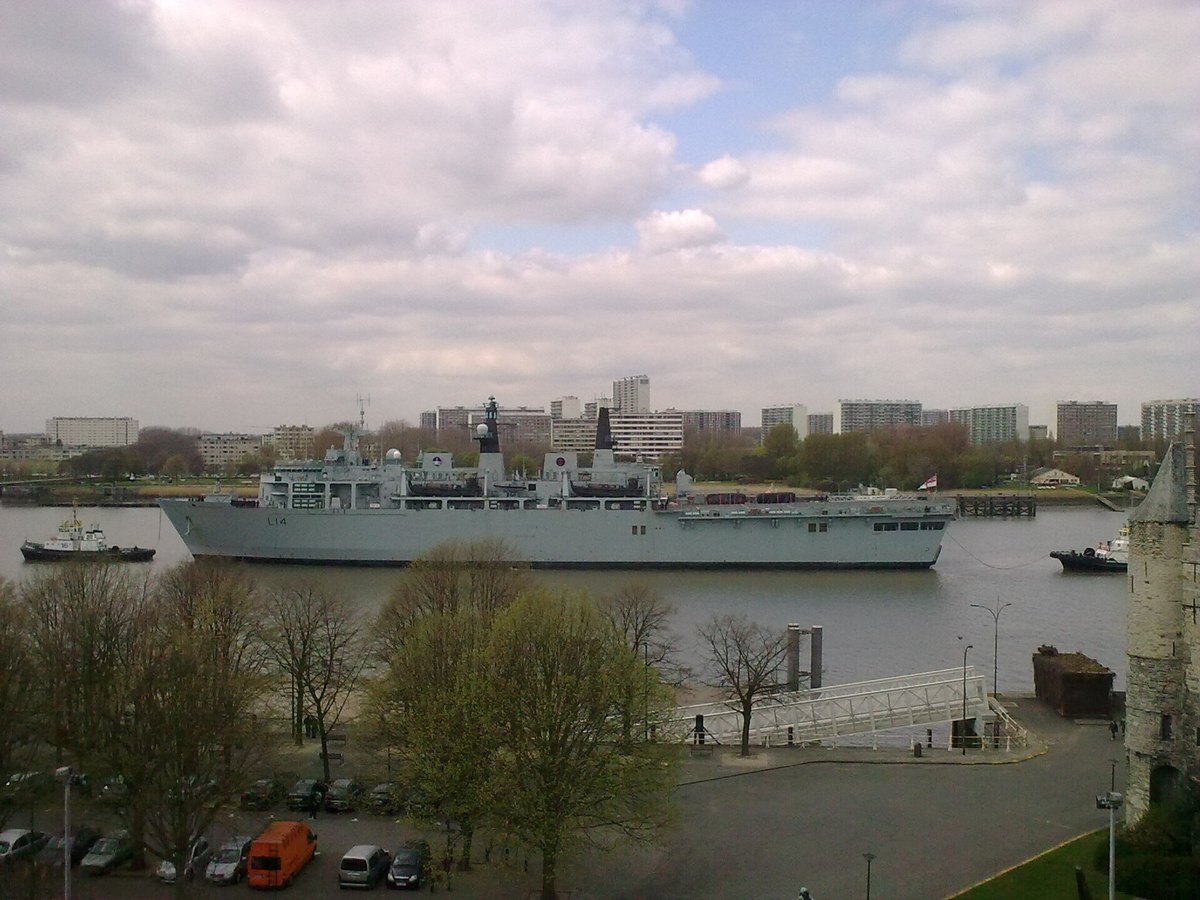 Ship passing Antwerp's historic waterfront on the Scheldt River