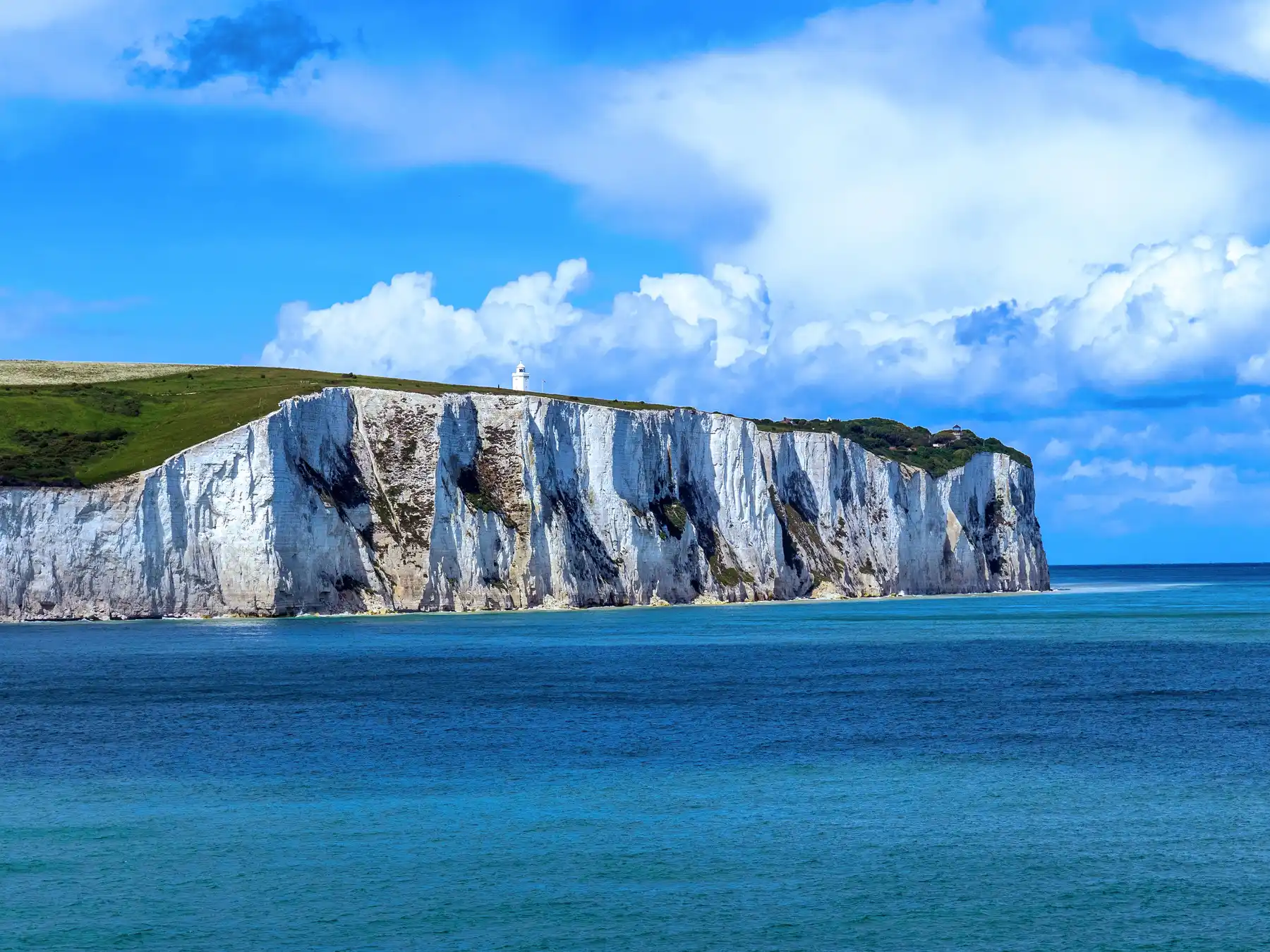 The White Cliffs of Dover above vivid blue water in the English Channel.