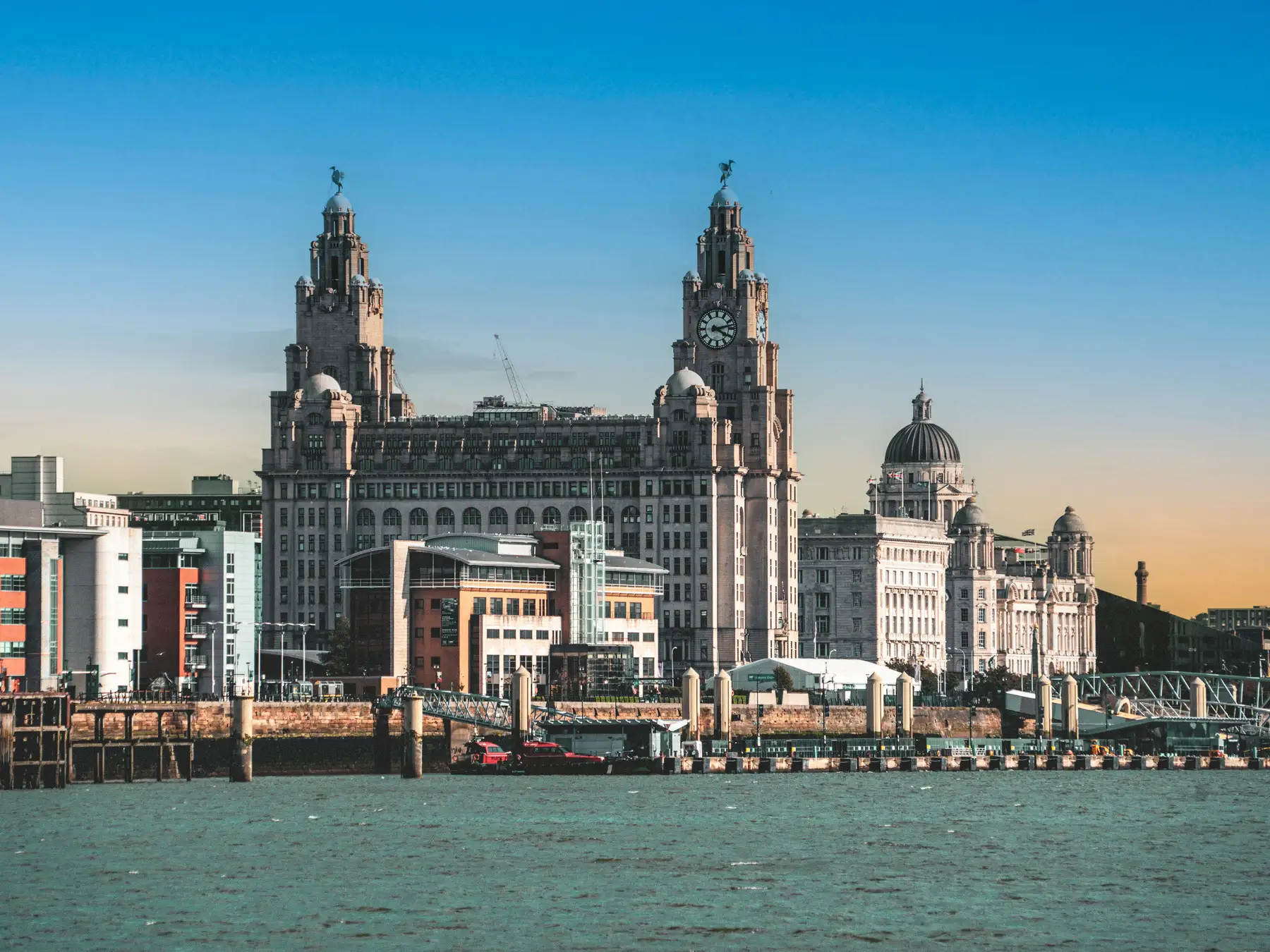 Royal Liver Building and Liverpool’s Three Graces seen across the River Mersey.