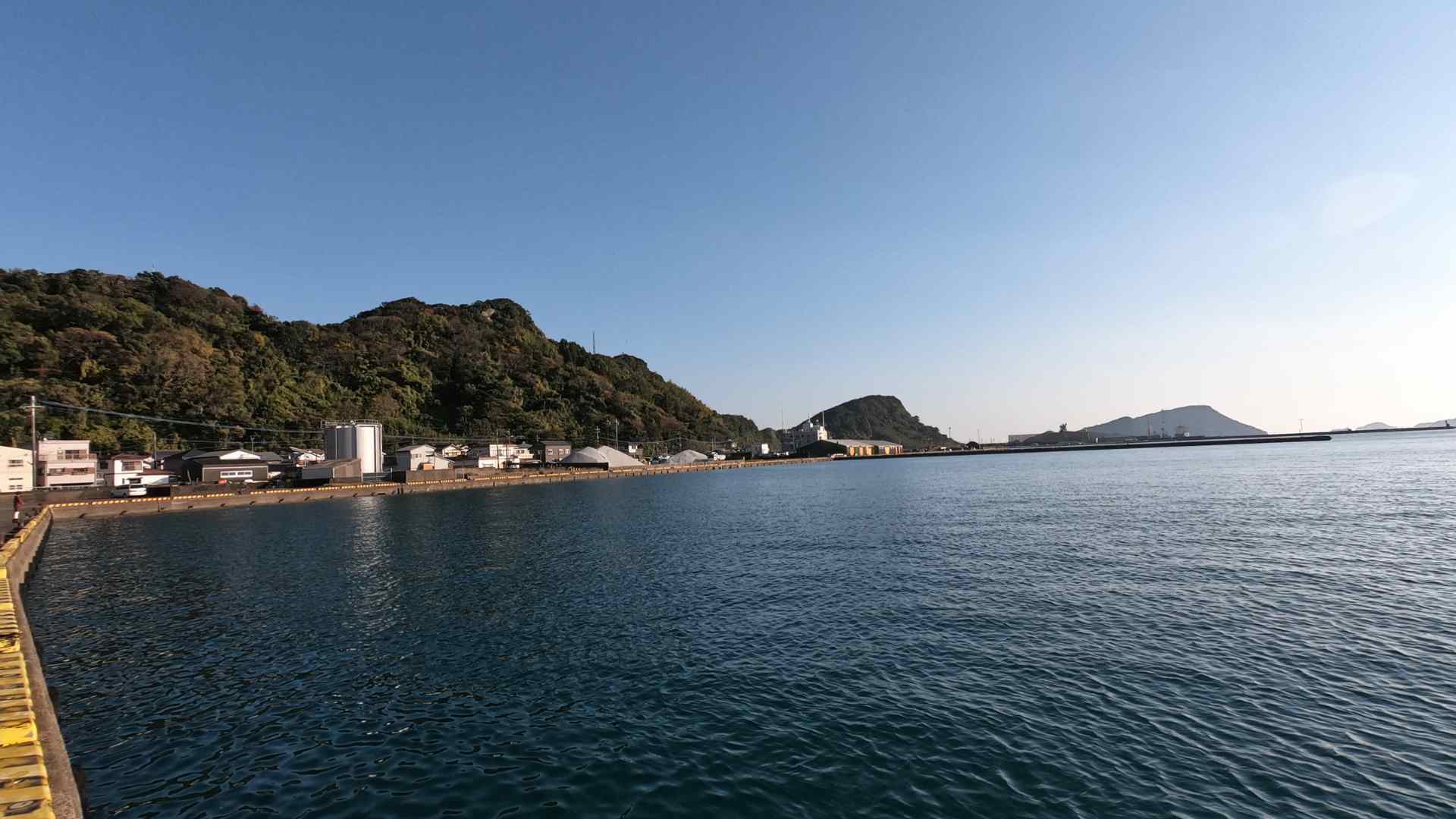 Calm harbor and forested coast at Aburatsu