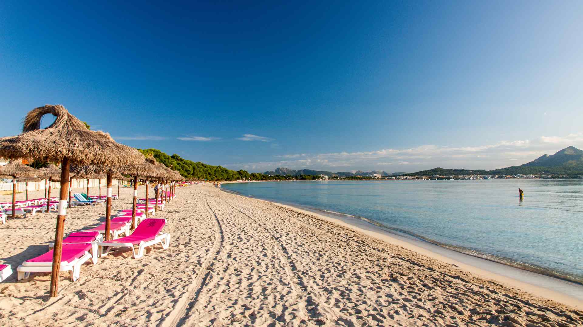 Wide sandy beach and calm water at Alcudia Bay