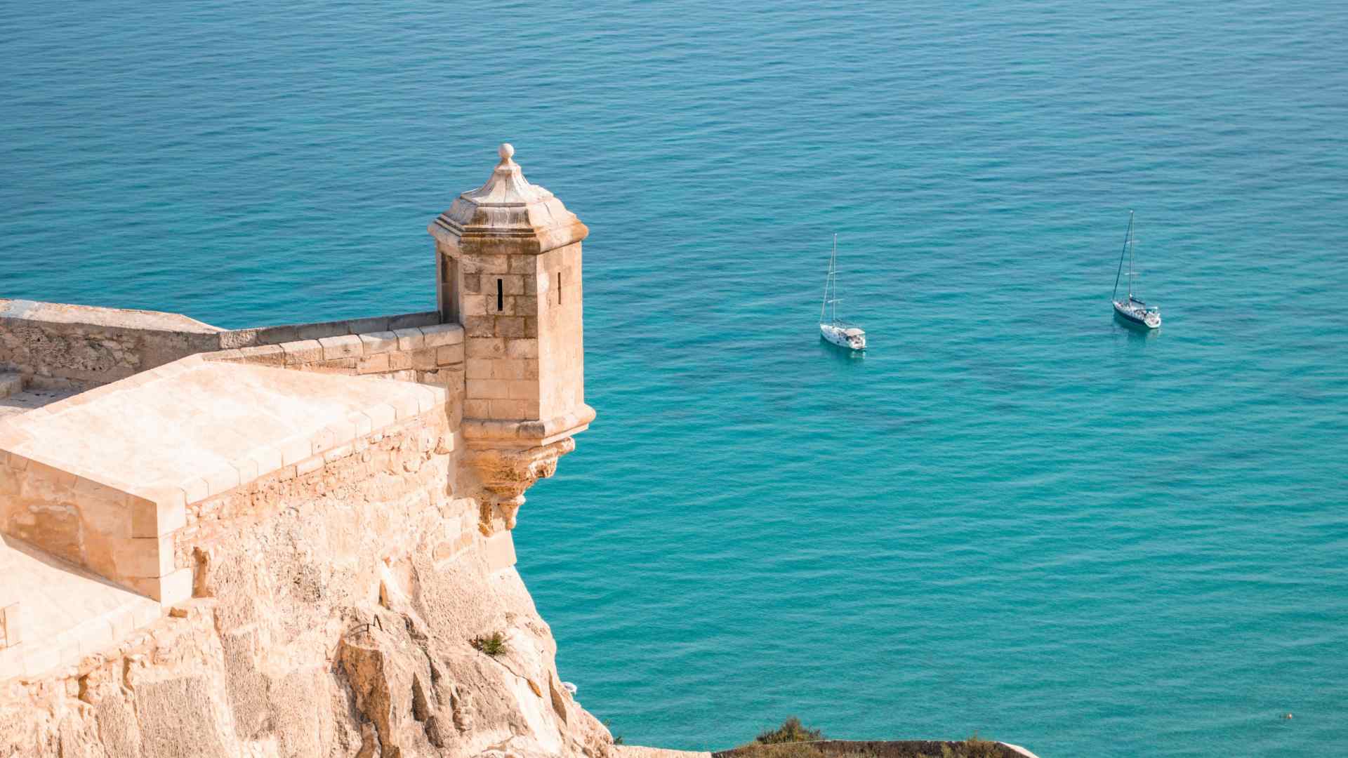 Castle turret overlooking the blue Mediterranean at Alicante