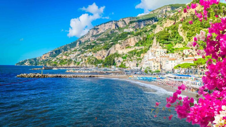 Amalfi town and coastline framed by bright bougainvillea