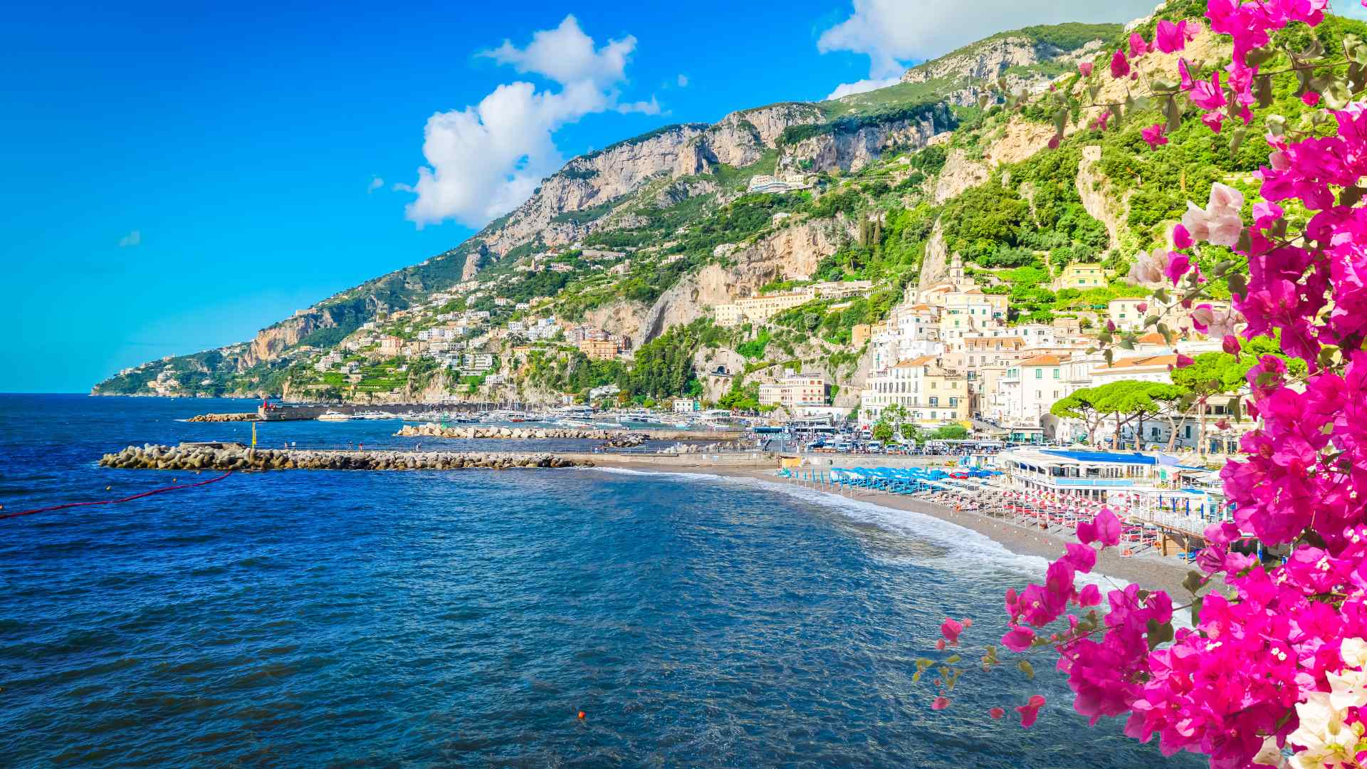 Amalfi town and coastline framed by bright bougainvillea