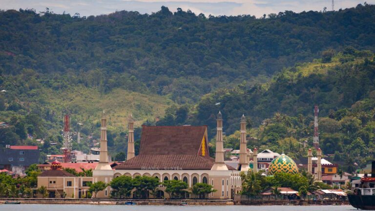 Mosque and green hills along the Ambon waterfront