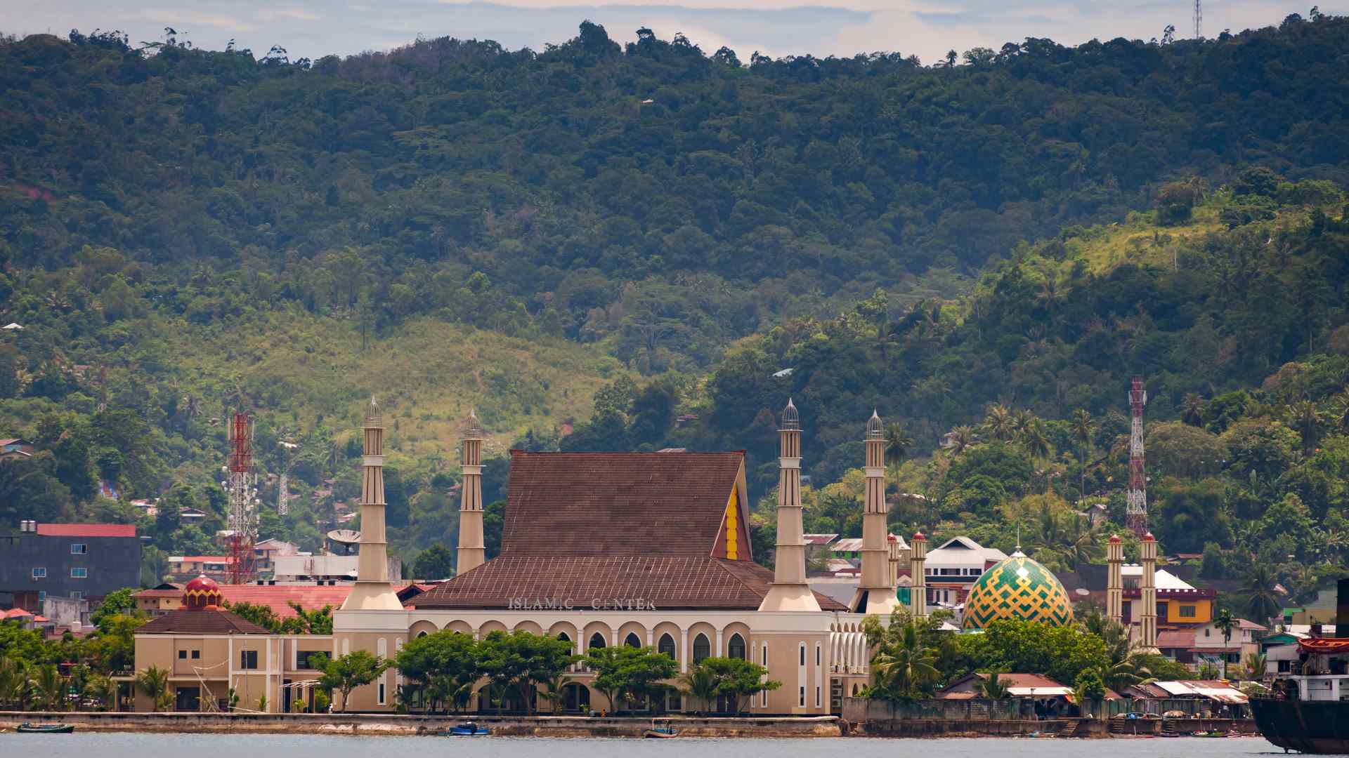Mosque and green hills along the Ambon waterfront