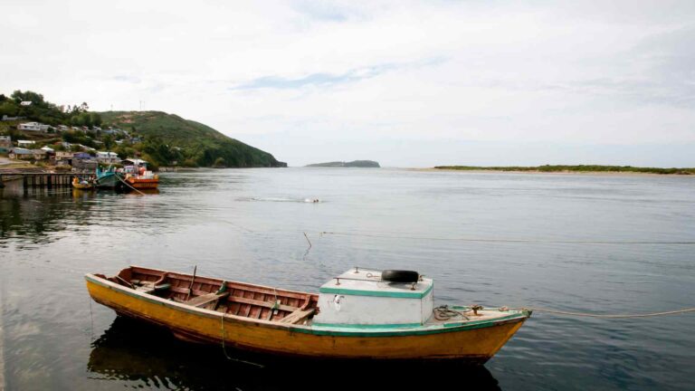 Small fishing boat on calm water near Ancud, Chile
