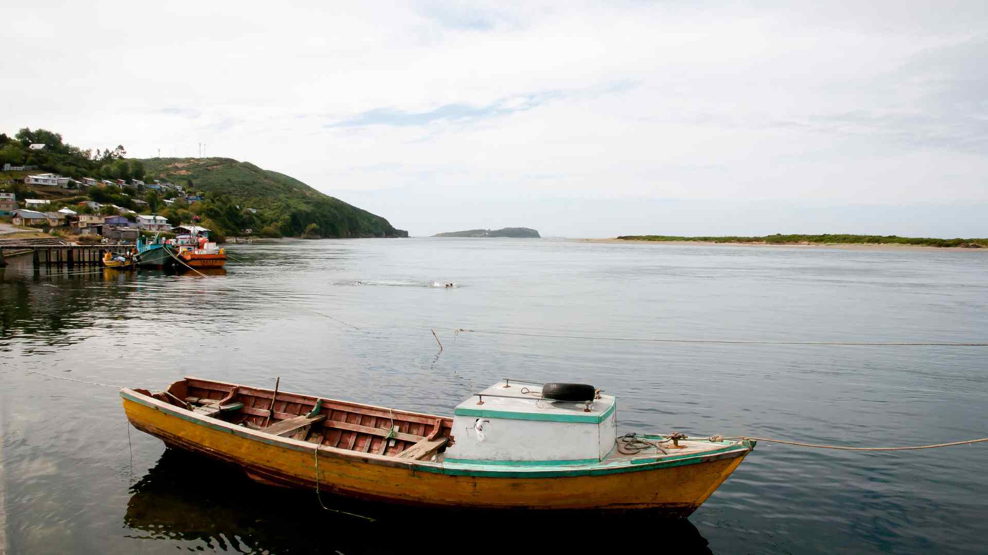Small fishing boat on calm water near Ancud, Chile