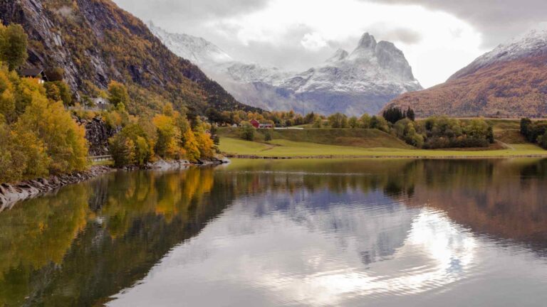 Romsdalen mountains reflected in a calm lake near Andalsnes