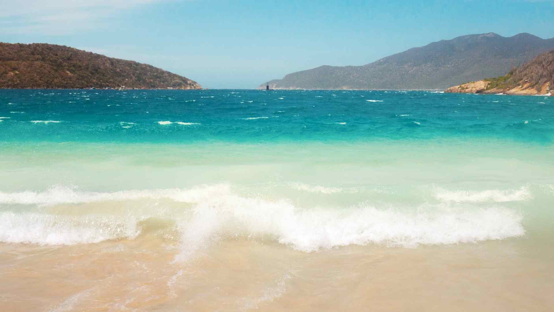 Turquoise surf on a sheltered Arraial do Cabo beach